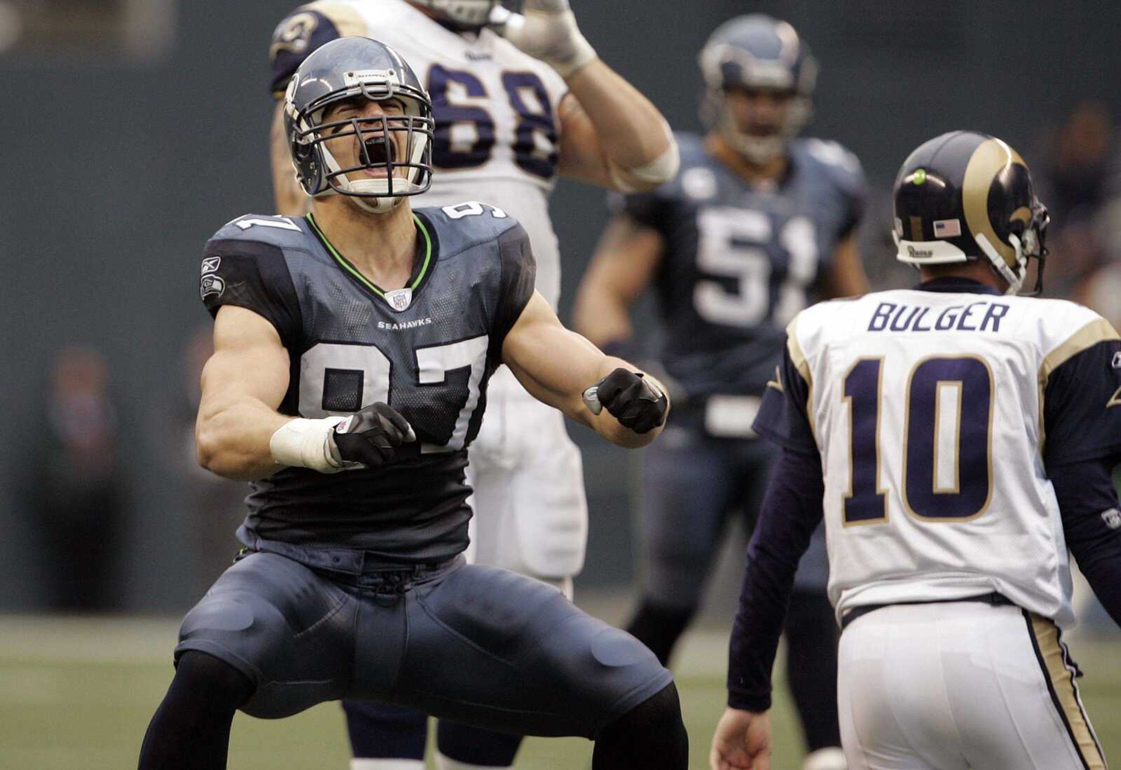 Seattle Seahawks defensive lineman Patrick Kerney yelled after sacking Rams quarterback Marc Bulger during the second half Sunday in Seattle. Bulger was sacked seven times in the game. (ELAINE THOMPSON ~ Associated Press)