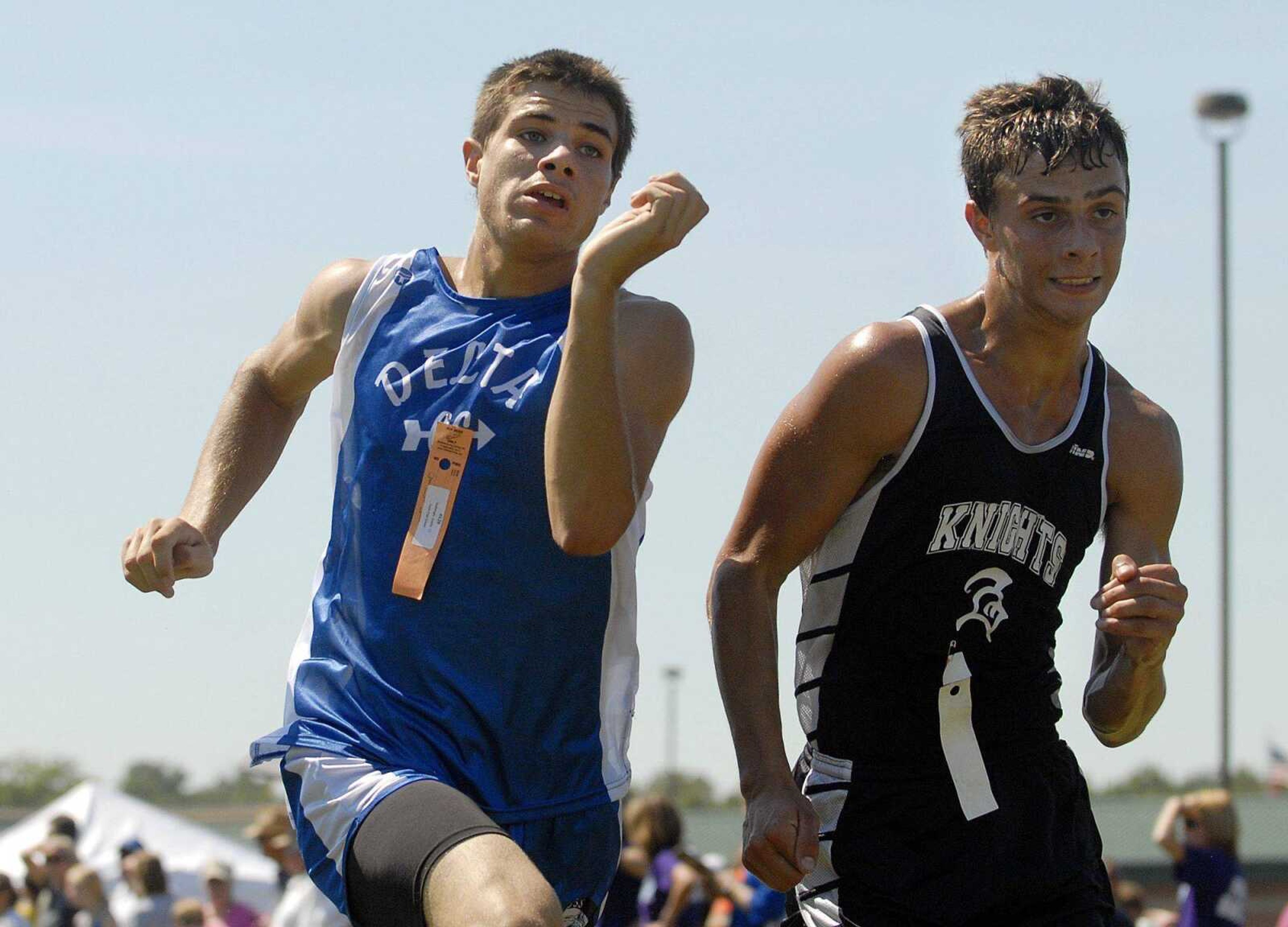 Delta senior Austin Seabaugh tries to muscle past Farmington junior Carl Wheeler at the finish line Saturday.