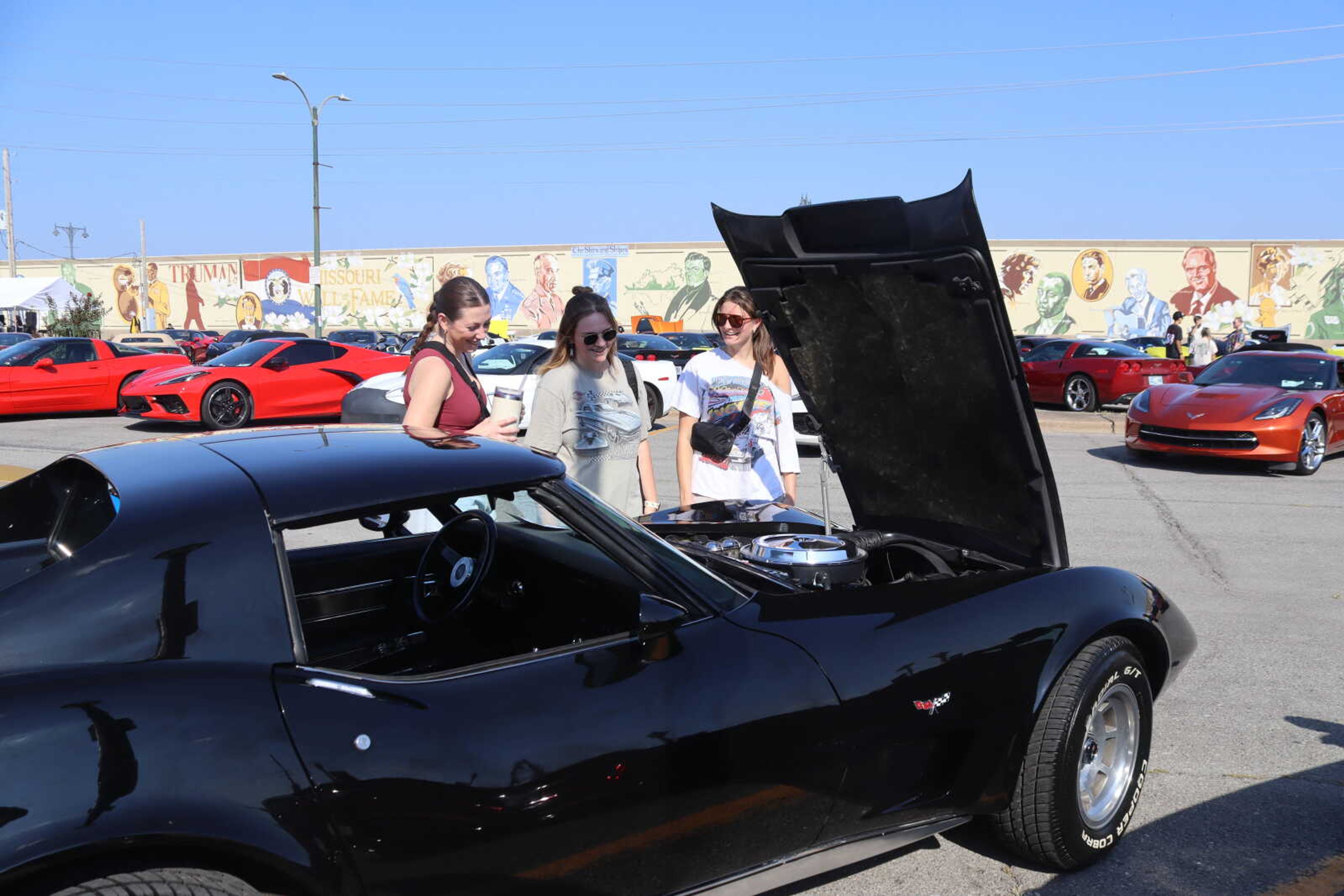 Charlotte Norton, Katie Marshall and Maliyah Phillips look at one of the many Corvettes parked in Downtown Cape Girardeau at the Corvette Caravan. 