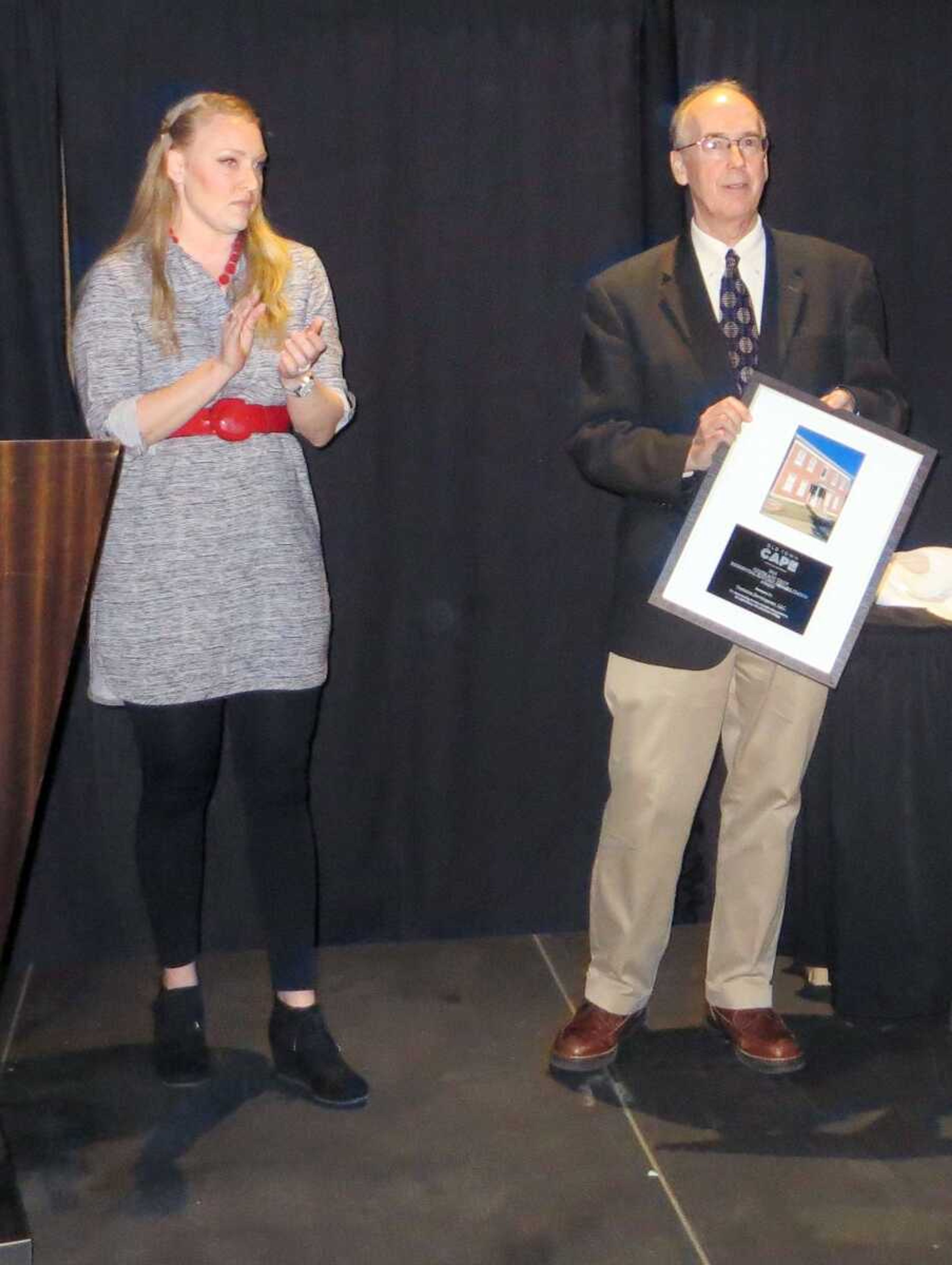 TYLER GRAEF ~ tgraef@semissourian.com
Cindy Buchheit and Steven Hoffman present an award during Old Town Cape's annual awards dinner at the Isle Casino Cape Girardeau Thursday, Feb. 23.