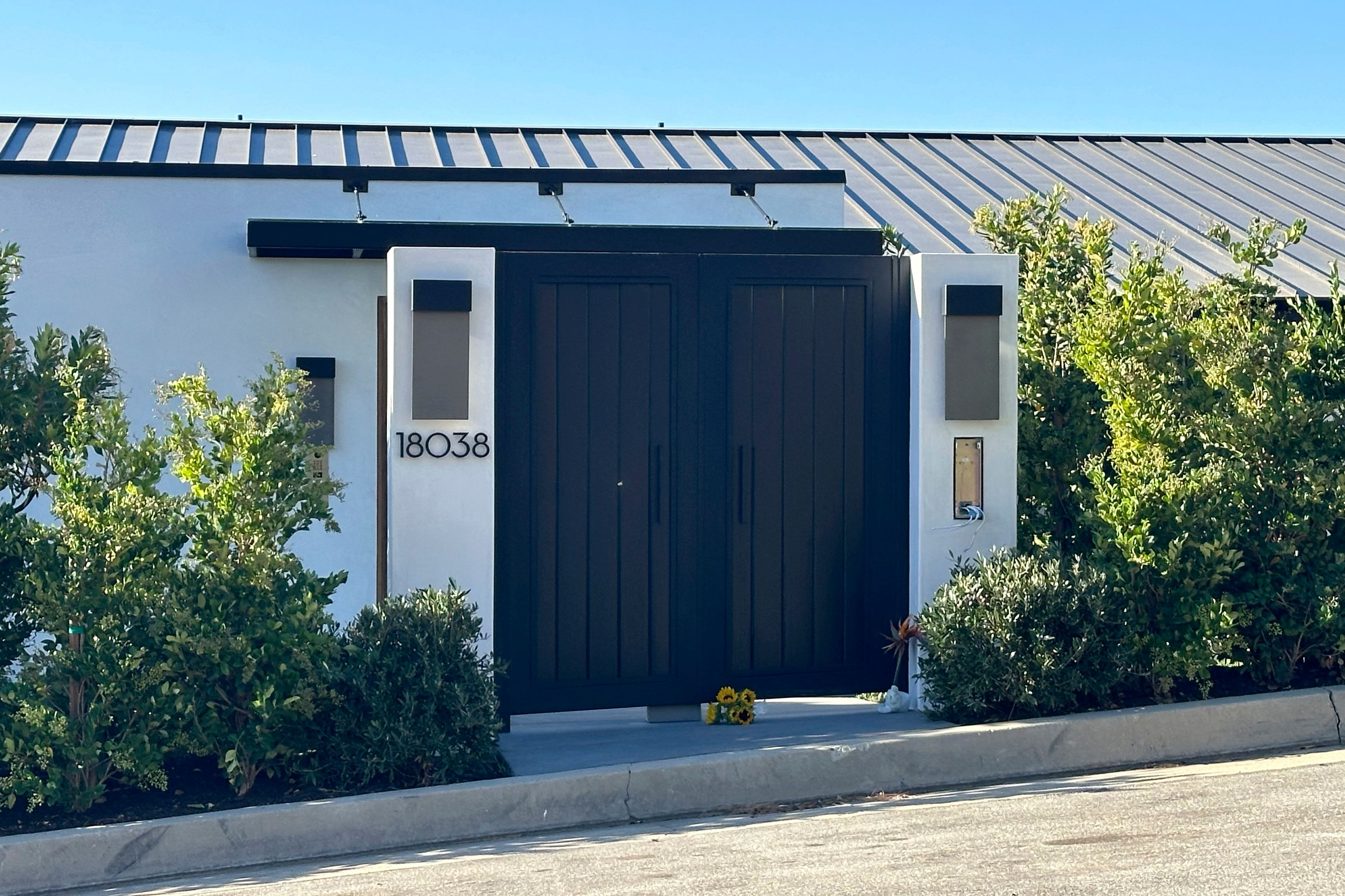 FILE - Flowers appear outside the home of actor Matthew Perry in Los Angeles on Oct. 29, 2023, a day after his death. A prosecutor says five people have been charged in connection with Perry’s death, including the actor’s assistant and two doctors. (AP Photo/Eugene Garcia, File)