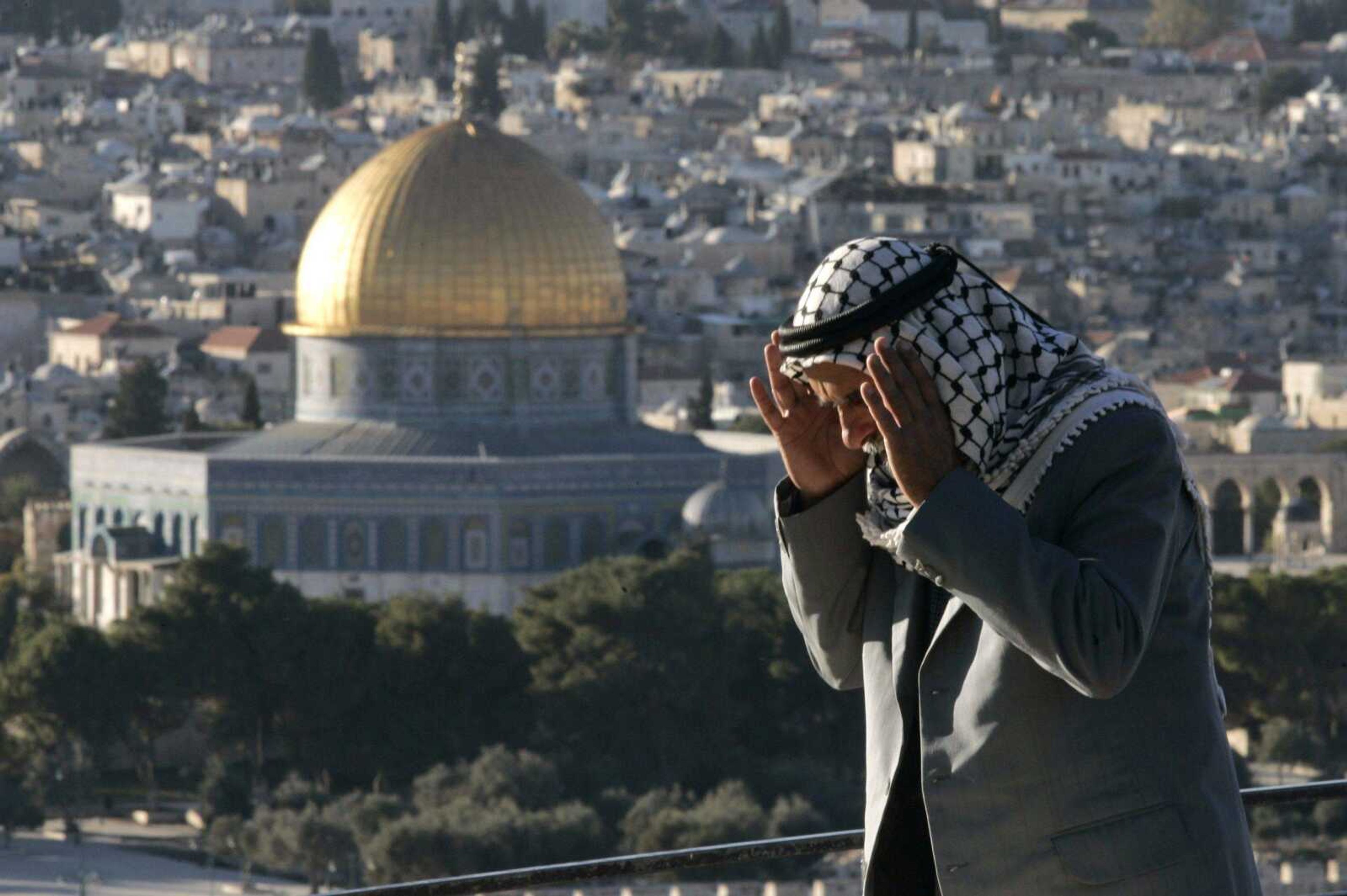 A Palestinian man prayed Wednesday on the Mount of Olives overlooking Jerusalem's Old City. The highly anticipated renewal of peace talks between Israelis and Palestinians got off to a rocky start Wednesday, with the Palestinians lambasting Israel for a new construction project planned in disputed East Jerusalem and Israel complaining about continued rocket fire from the Gaza Strip. (Sebastian Scheiner ~ Associated Press)