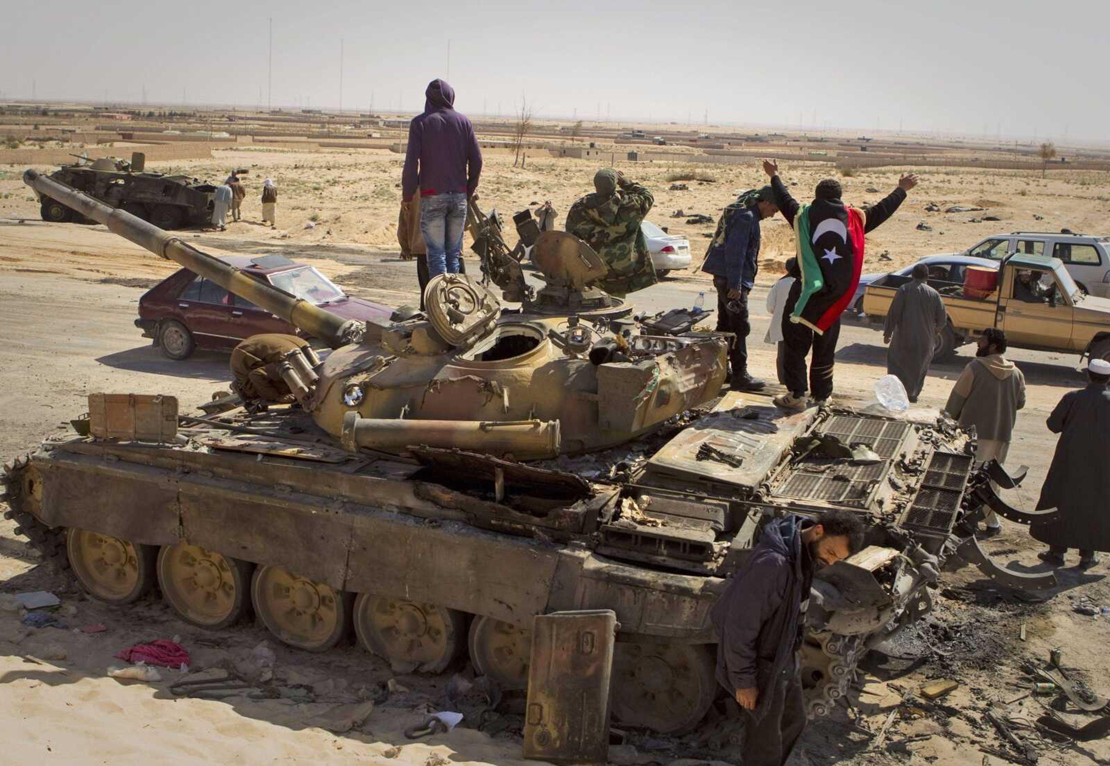 Libyan rebels celebrate on a captured tank Saturday after taking Ajdabiya, south of Benghazi, Libya. Libyan rebels regained control of the eastern gateway city after international airstrikes on Moammar Gadhafi's forces, in the first major turnaround for an uprising that once appeared on the verge of defeat. (Anja Niedringhaus ~ Associated Press)