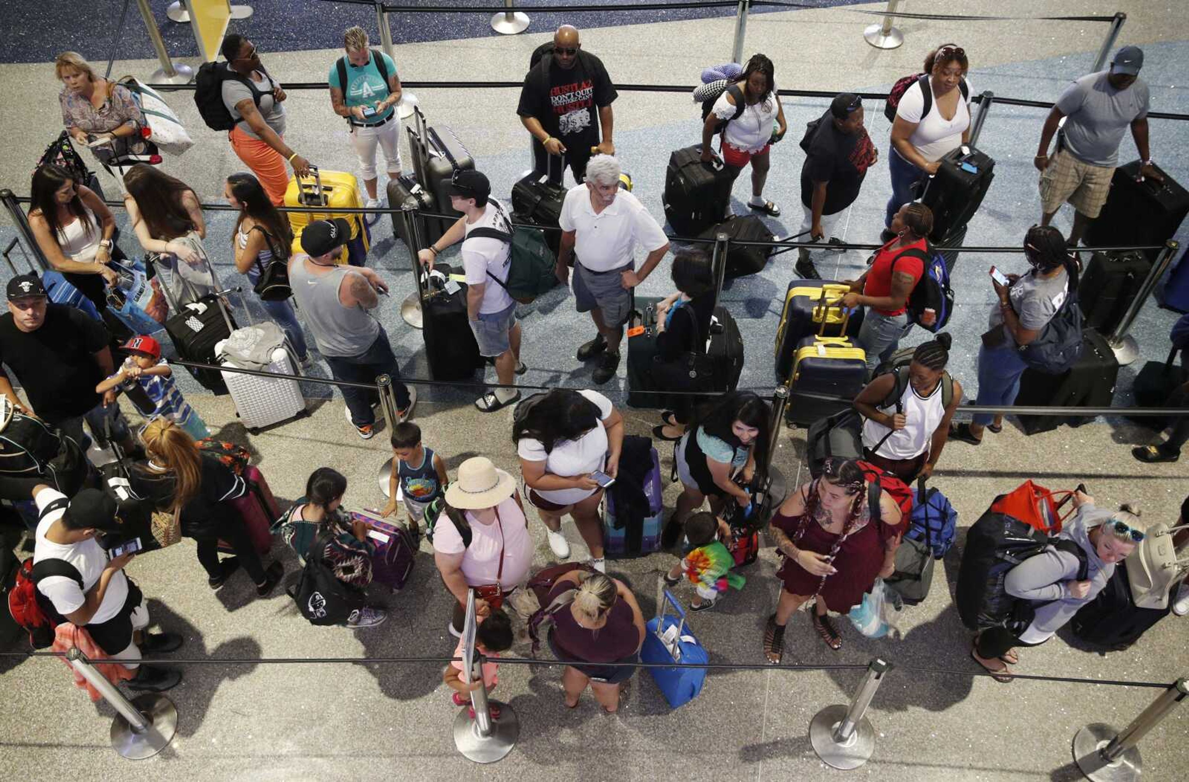 People wait in line June 29 to check in at McCarran International Airport in Las Vegas.