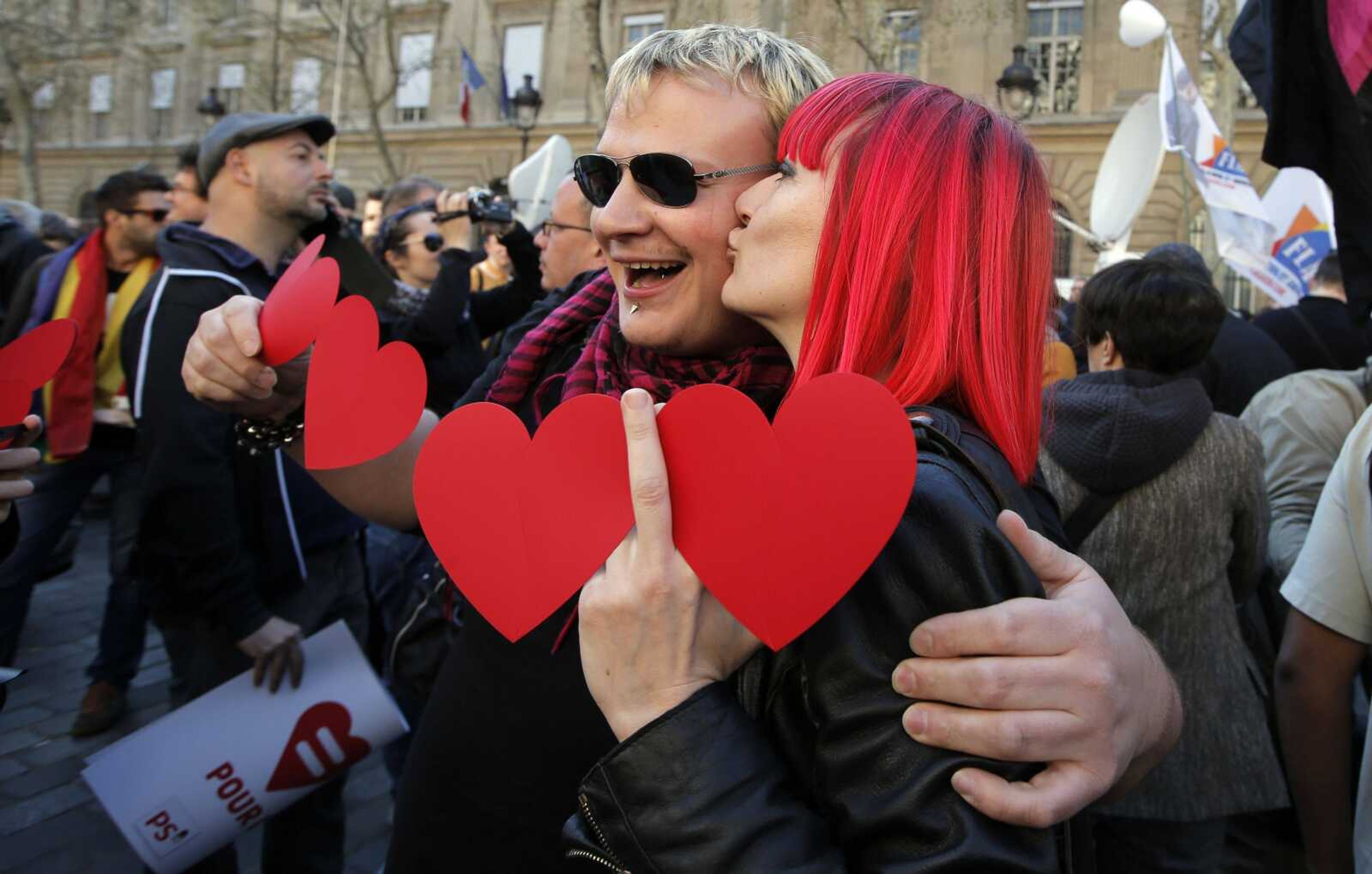 Pro gay marriage activists kiss after French lawmakers legalized same-sex marriage, Tuesday, April 23, 2013 in Paris. Lawmakers legalized same-sex marriage after months of bruising debate and street protests that brought hundreds of thousands to Paris. Tuesday's 331-225 vote came in the Socialist majority National Assembly. France's justice minister, Christiane Taubira, said the first weddings could be as soon as June. (AP Photo/Francois Mori)