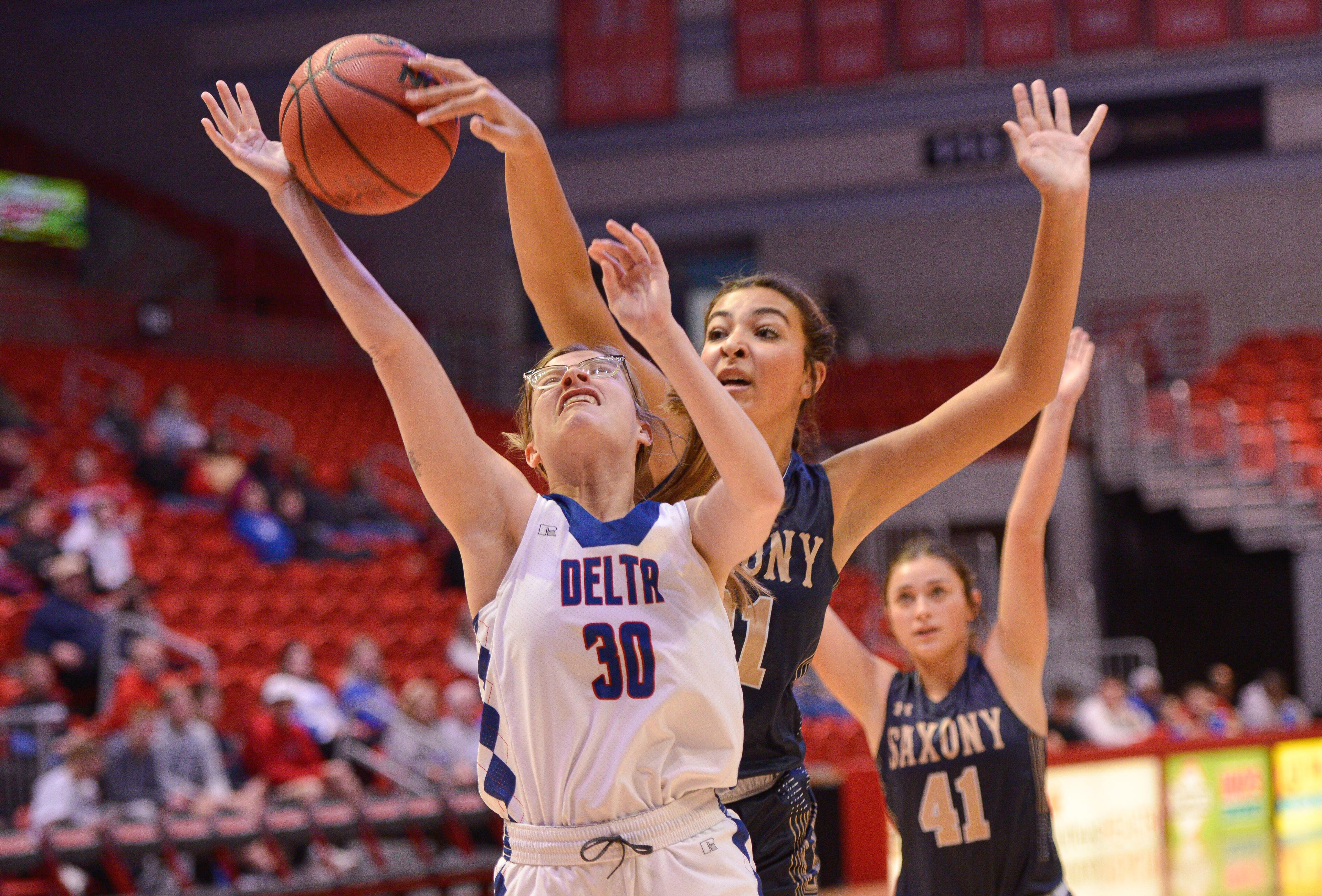 Saxony's Evie Caruso (right) blocks a shot during the 2023 First State Community Bank championship game between the Delta Ladycats and the Saxony Lutheran Crusaders at the Show Me Center in Cape Girardeau, Mo. Delta defeated Saxony Lutheran, 52-45.