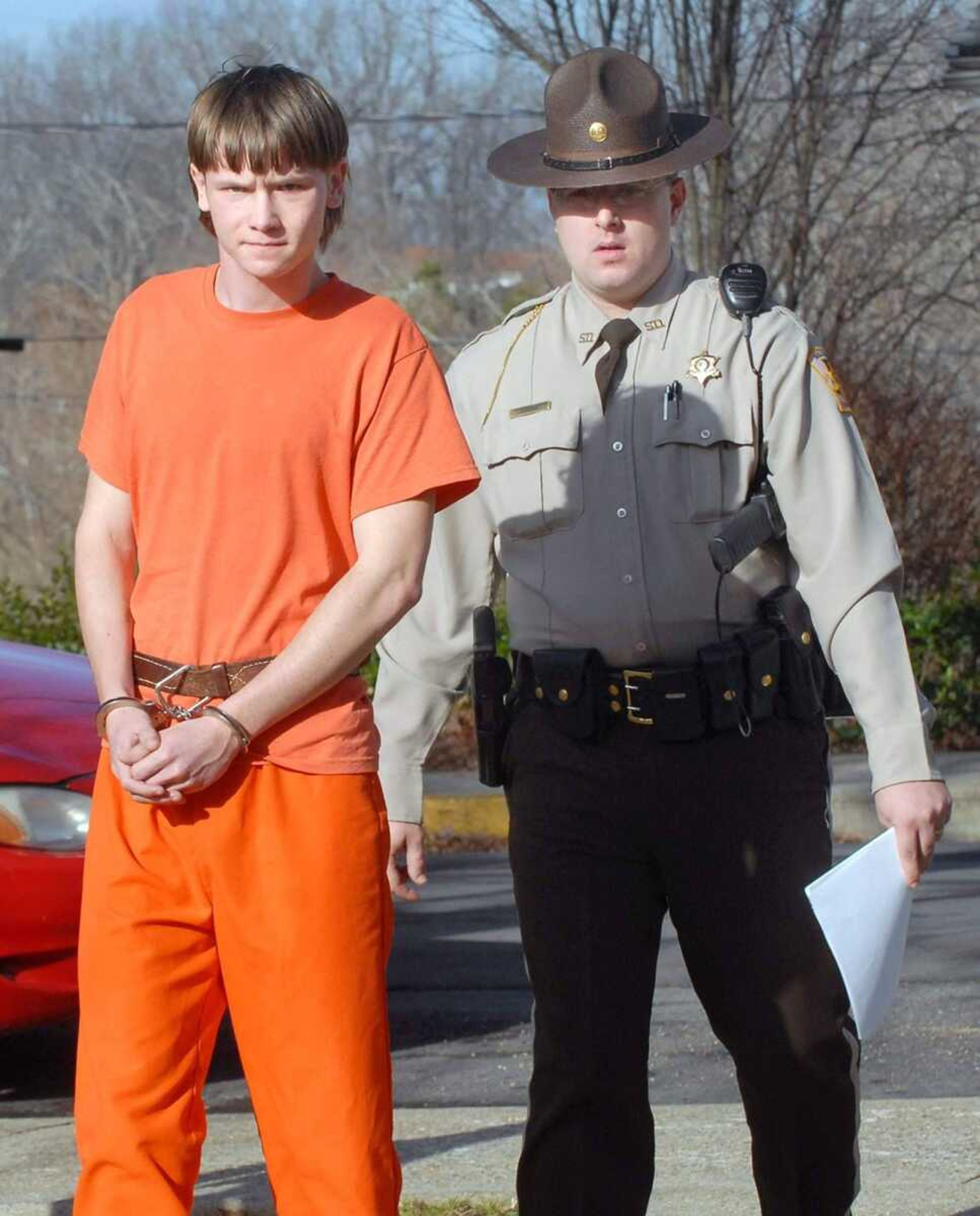 Bollinger County Sheriff's Deputy Steven McCain, right, escorts 17-year-old John W. Wilfong to the Bollinger County Jail following an arraignment Jan. 7 in Marble Hill.