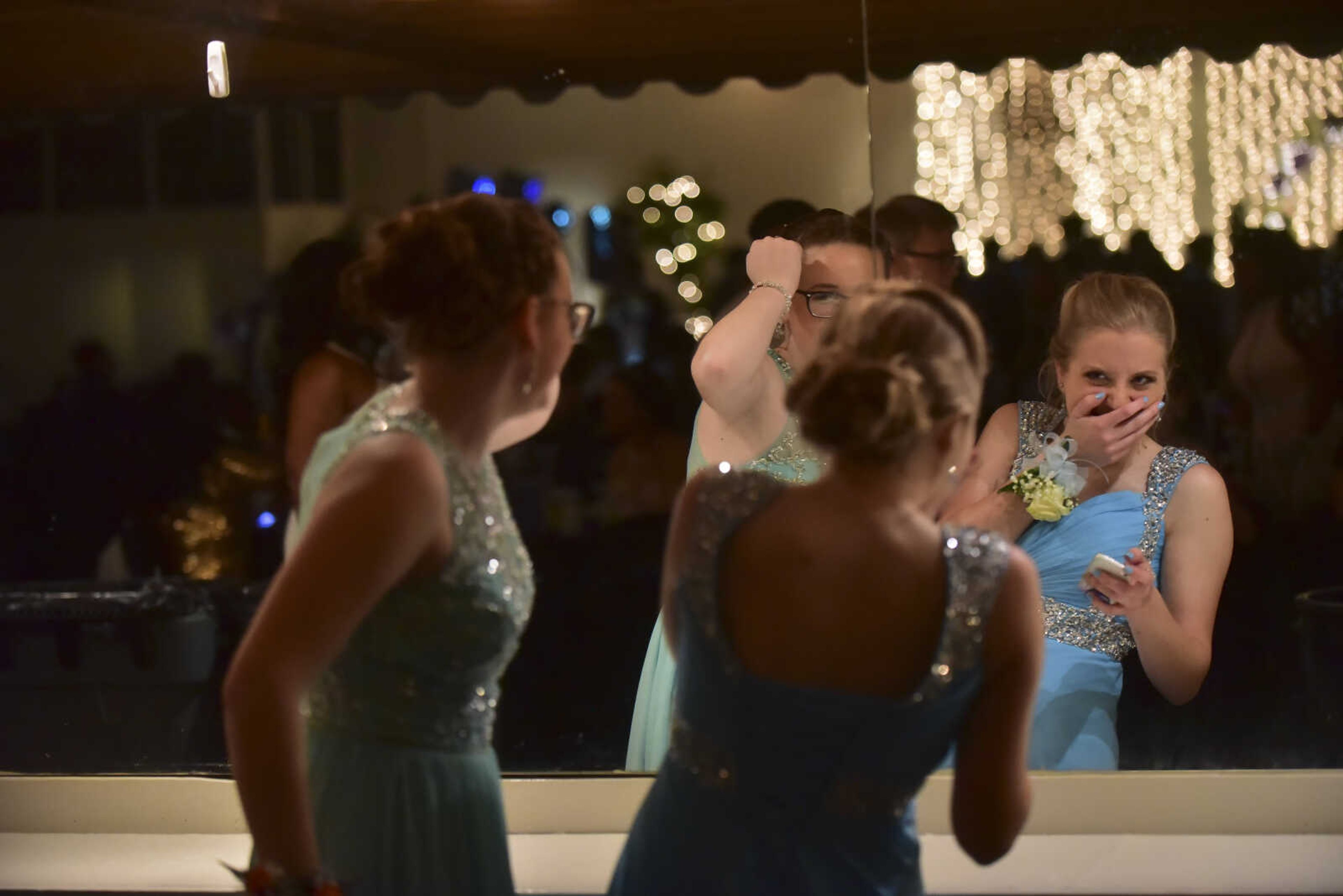 Cape Central students look in a mirror during the Cape Girardeau Central prom Saturday, April 29, 2017 at Ray's Plaza Conference Center in Cape Girardeau.