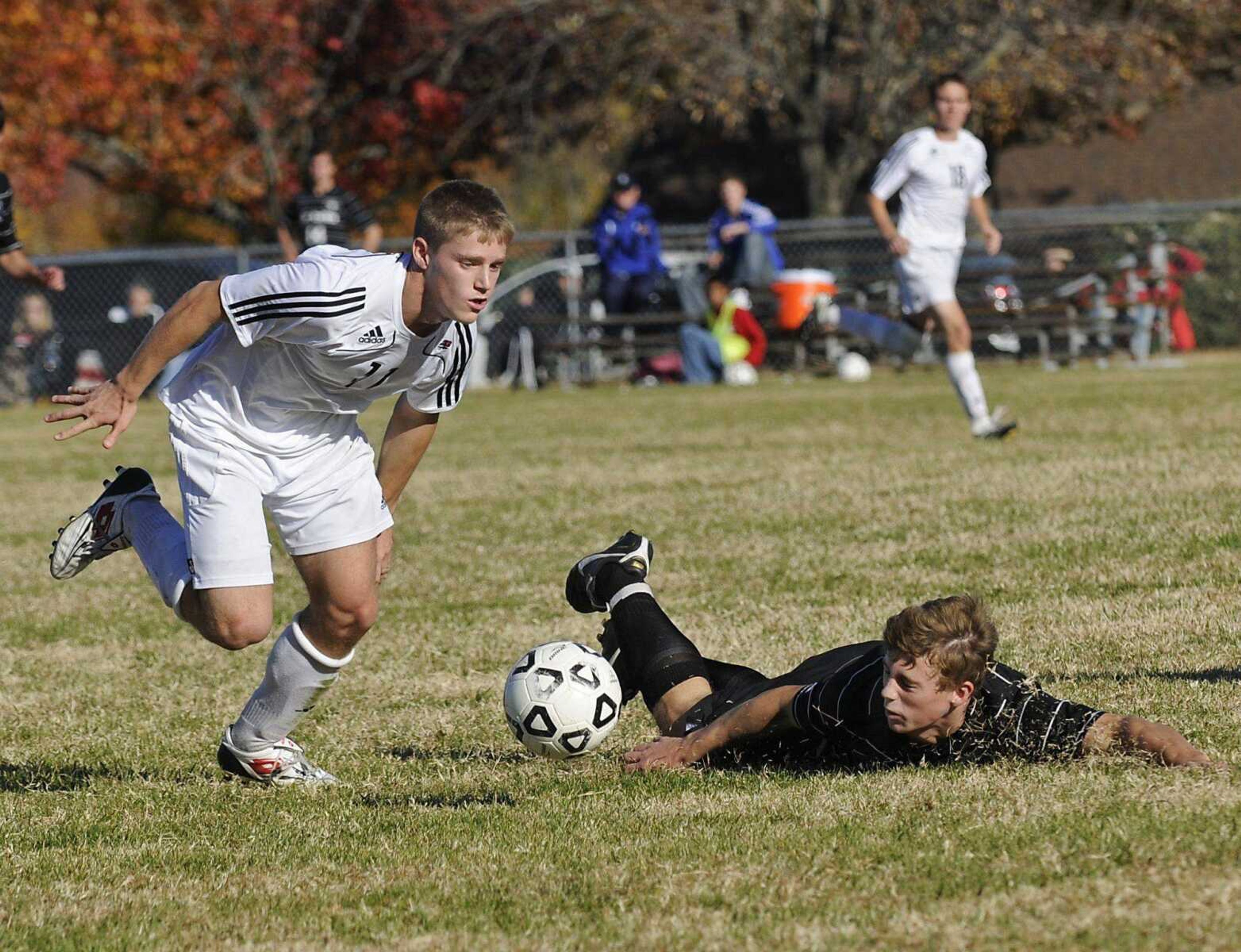 St. Louis University High's Joe Rund takes a fall as Jackson's Law Duncan moves the ball down-field during the second half of a boys Class 3 quarterfinal game on Saturday, Nov. 13, 2010, in Jackson. Jackson lost 4-1. (Kristin Eberts)