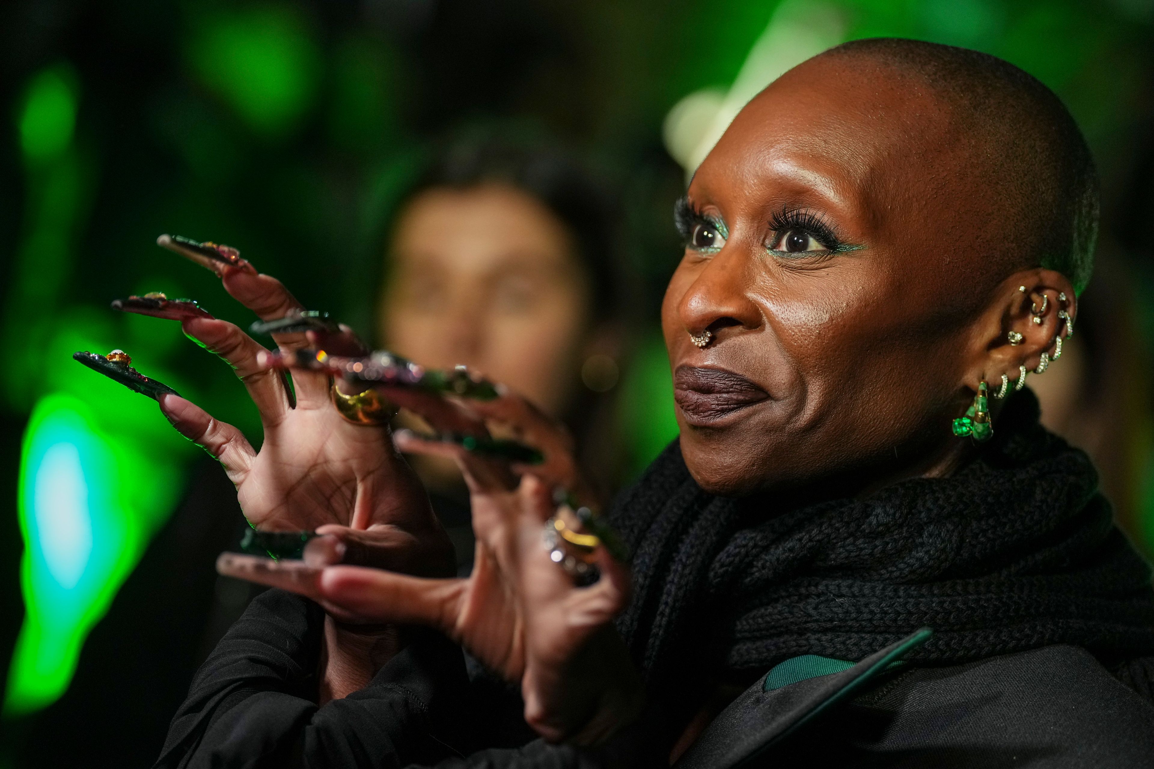 FILE - Cynthia Erivo poses for photographers at a photo call for the film 'Wicked' on Wednesday, Nov. 20, 2024, in London. In “Wicked,” Elphaba and Glinda travel from Shiz University to the Emerald City on a glistening green train to meet the wizard. In real life, Cynthia Erivo and Ariana Grande have traveled much farther and wider and longer and on airplanes to promote their hotly anticipated film. (Photo by Scott A Garfitt/Invision/AP, File)