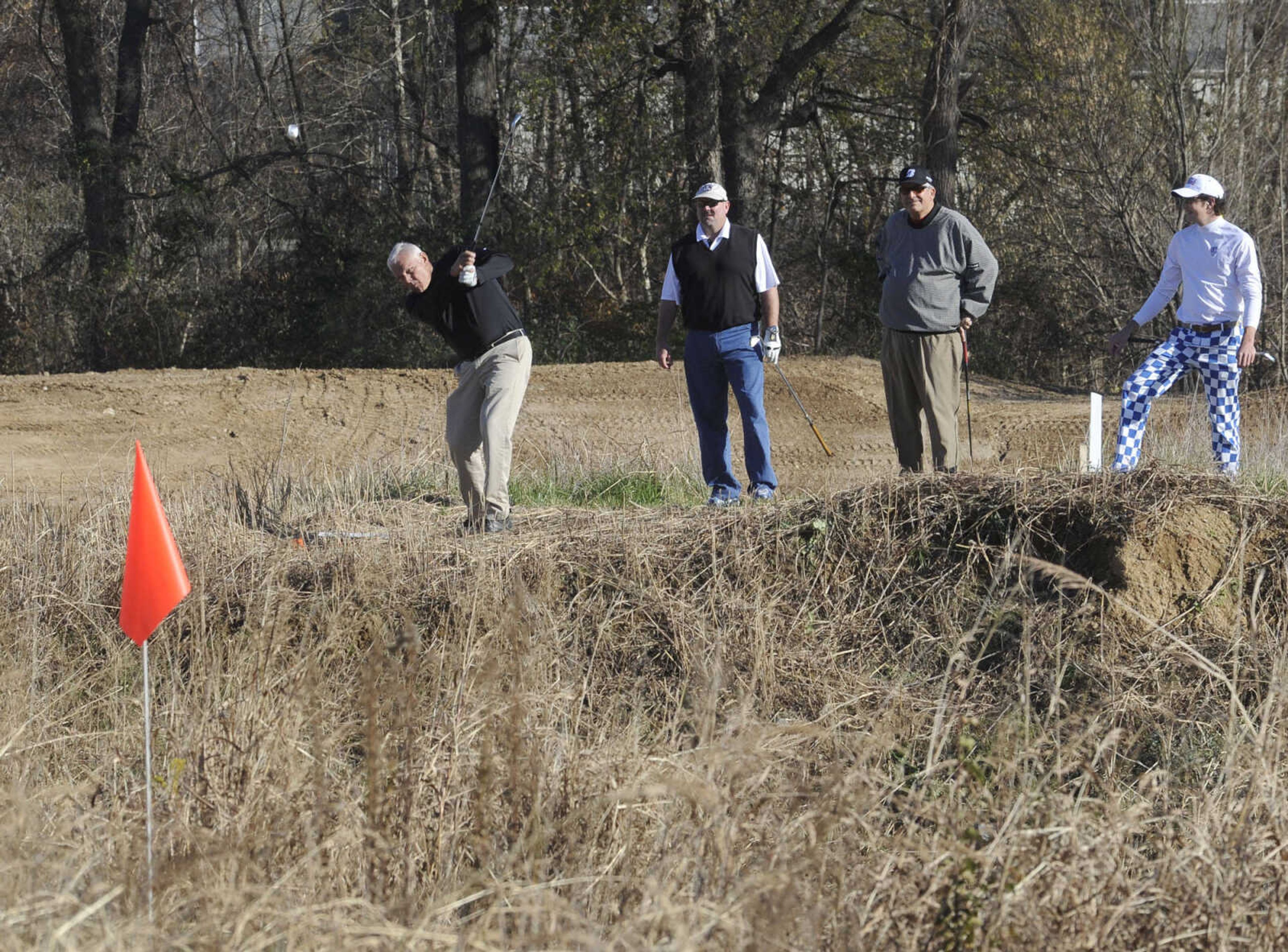 Dr. Mike Bennett hits a BirdieBall from the 16th teebox with, from left, Jay Knudtson, Greg Brune and Gunnar Knudtson at the Discovery Playhouse Open.