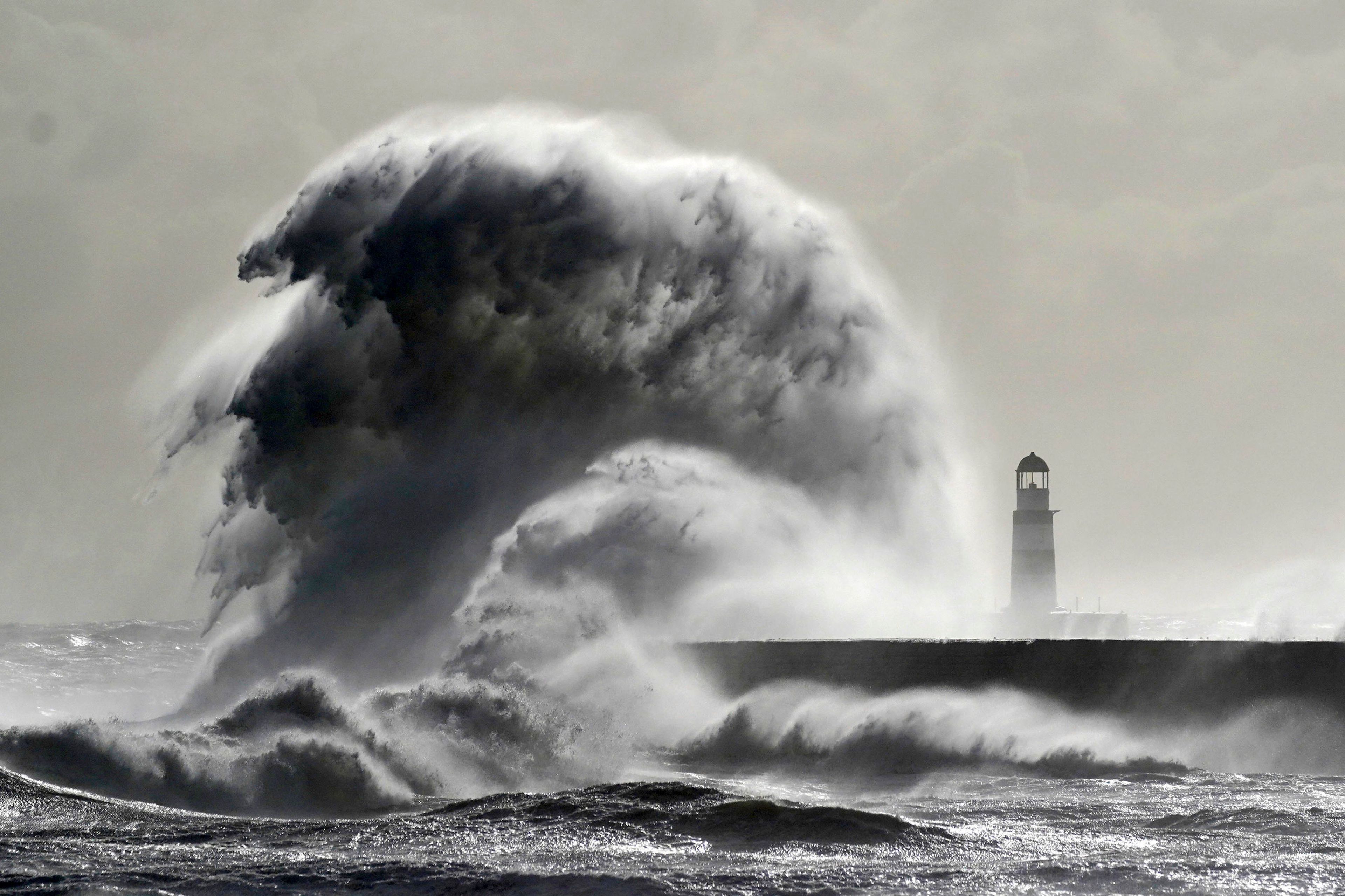 Waves crash against the lighthouse in Seaham Harbour, County Durham, England, Friday, Sept. 27, 2024. (Owen Humphreys/PA via AP)