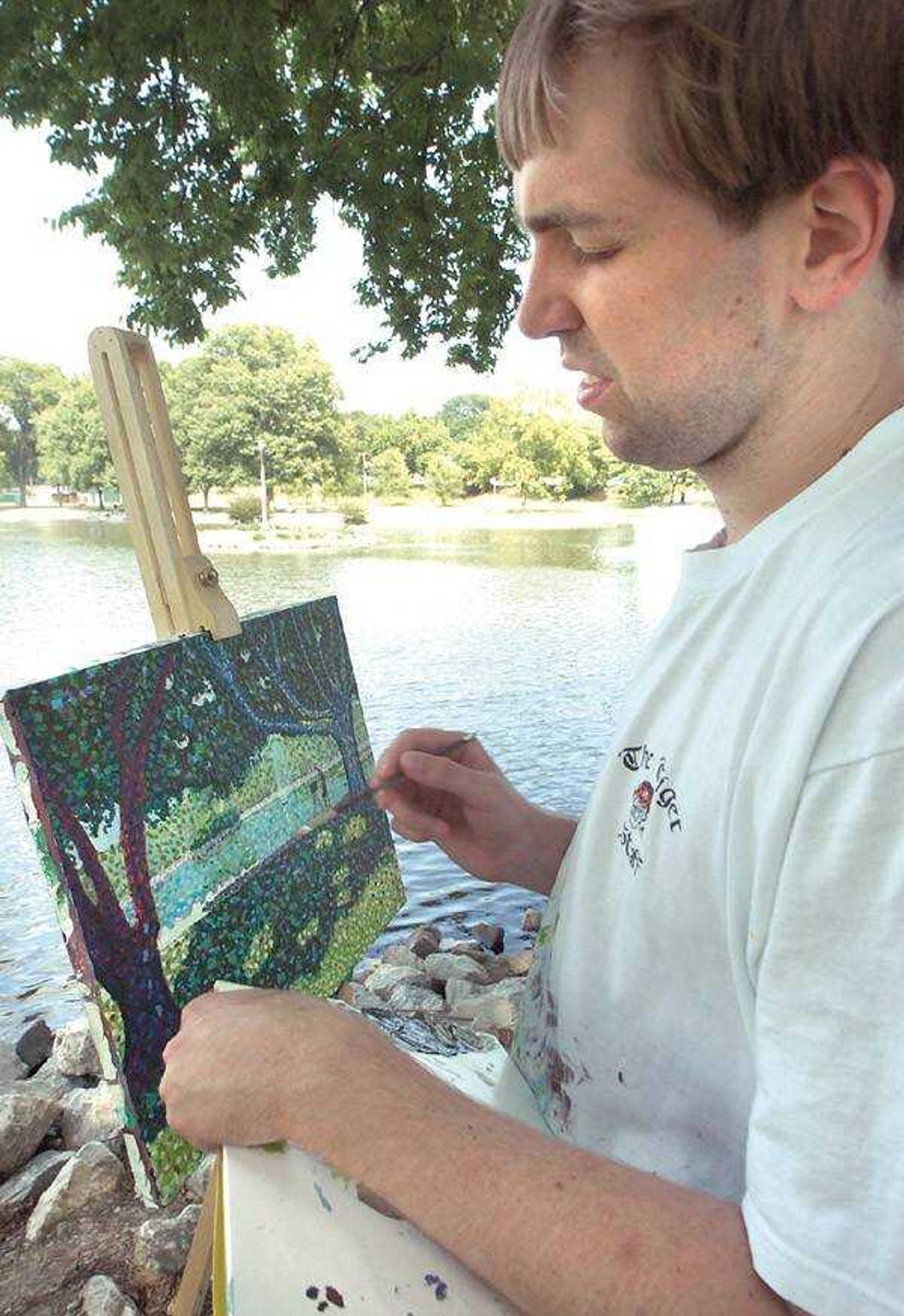 Taylor Crowe used a pointillism style of painting at Capaha Park lagoon on a work he will use to open his presentation, "The View from Here: My Life with Autism," at a conference in Dallas on Sept. 8. (Fred Lynch)