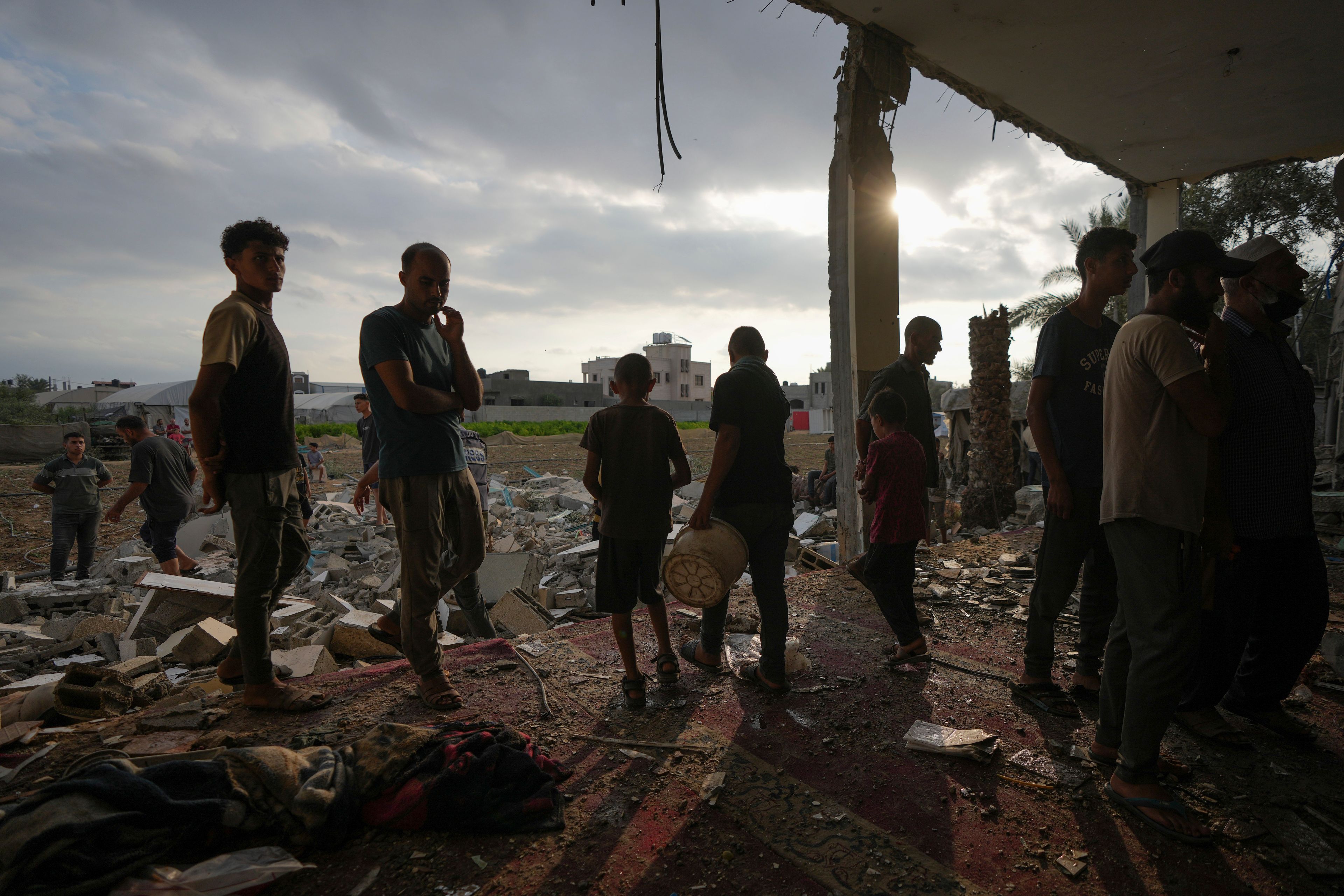 Palestinians examine a destroyed mosque following an Israeli airstrike in Deir al-Balah, Sunday, Oct. 6, 2024. (AP Photo/Abdel Kareem Hana)