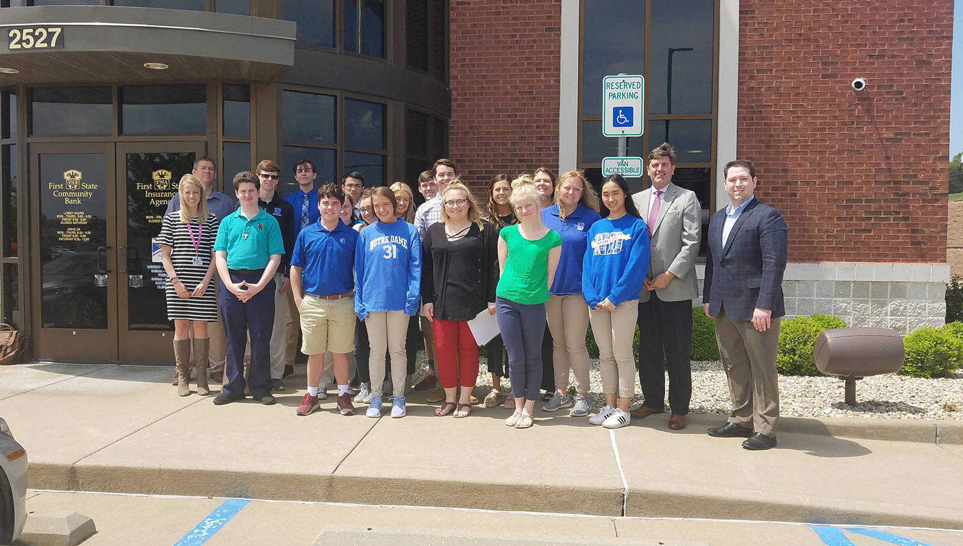 Business law students at Notre Dame Regional High School pose for a photo with the Dawg Fight judges at First State Community Bank.