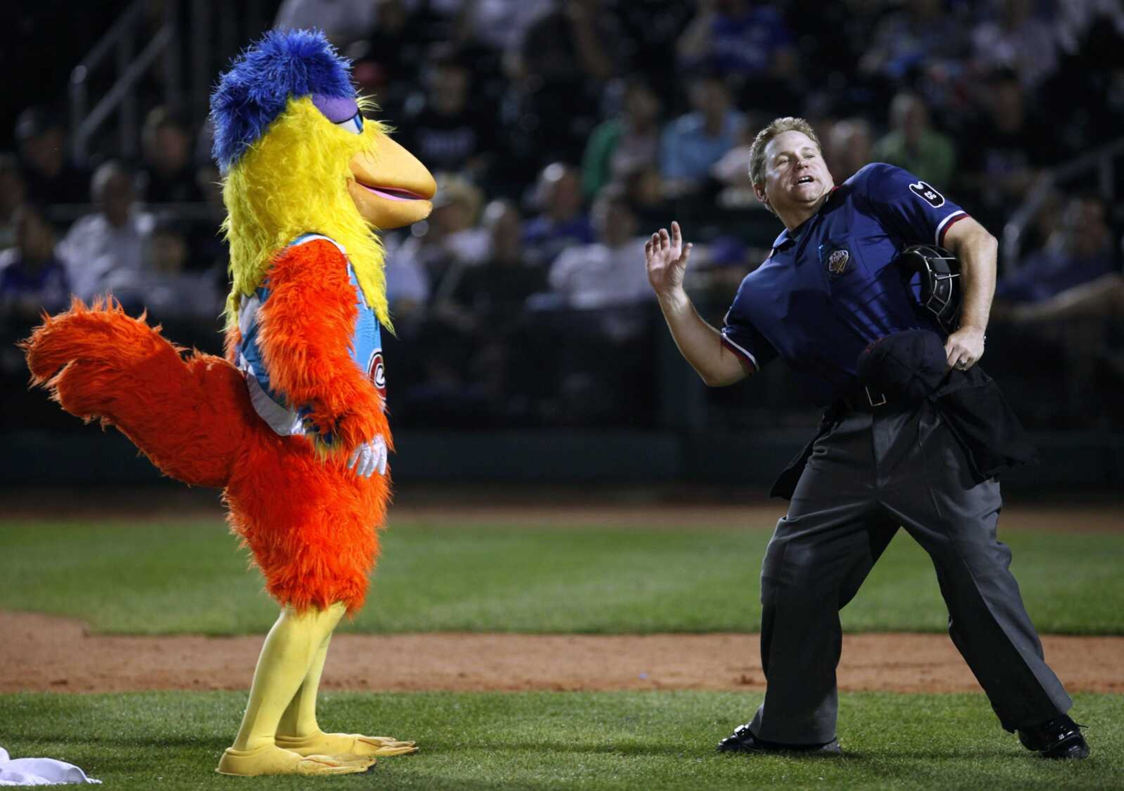 The San Diego Chicken performs with home plate umpire Mike Muchlinski during the Iowa Cubs' game against the Omaha Royals, Thursday, June 11, 2009, in Des Moines, Iowa. Ted Giannoulas has been playing the San Diego Chicken since the mid-1970s. (AP Photo/Charlie Neibergall)