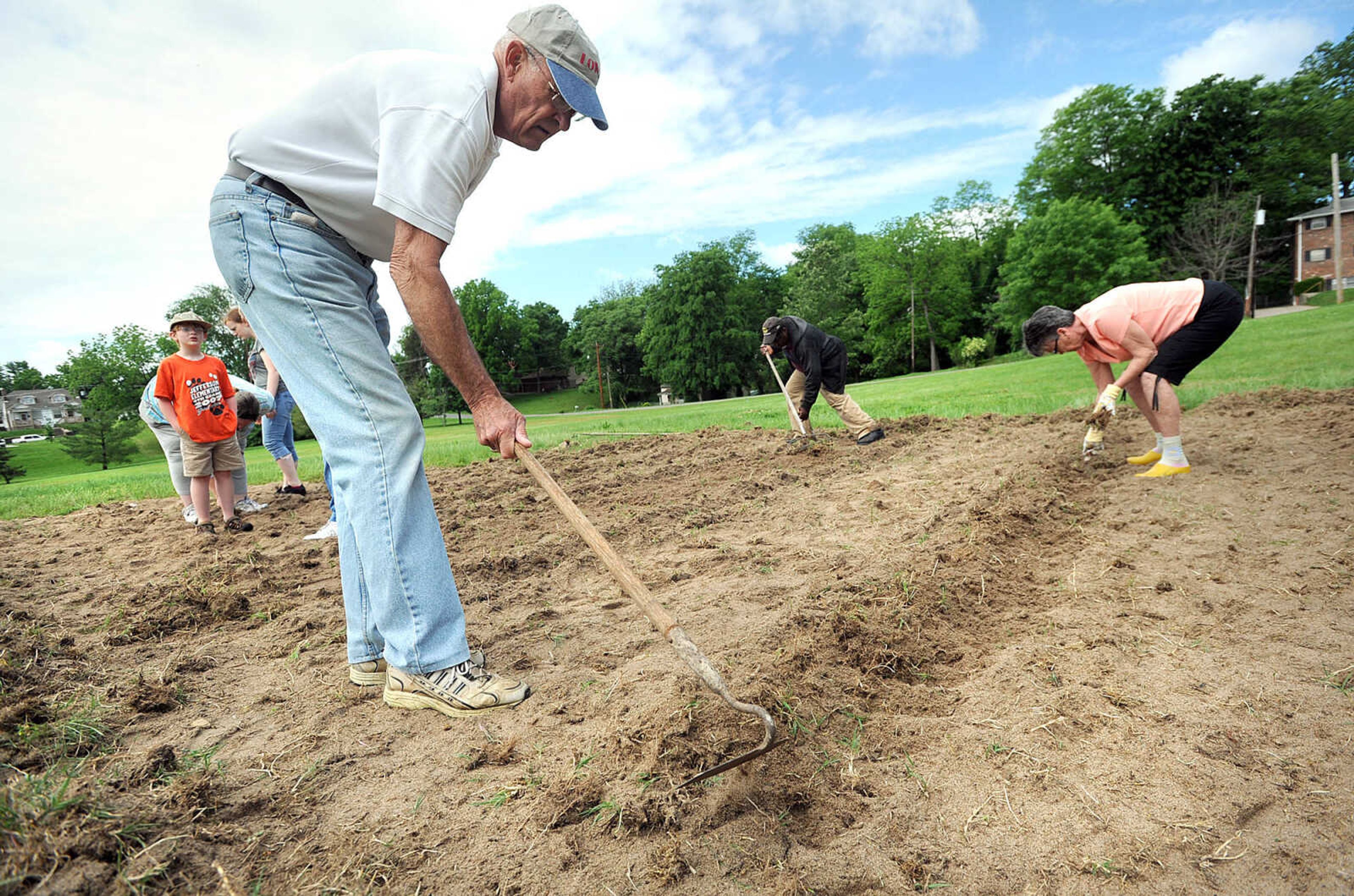 LAURA SIMON ~ lsimon@semissourian.com

From left, Bill Green, Master Gardener Robert Harris, and Marian Green work in the new community garden in Washington Park, Wednesday, May 22, 2013 in Cape Girardeau. The Neighborhood Connections garden has two rows each of deer resistant okra, yellow squash and cucumbers. Cub Scout Pack 18 is helping with the garden to "help them appreciate where food comes from," pack leader Margery Smith said.