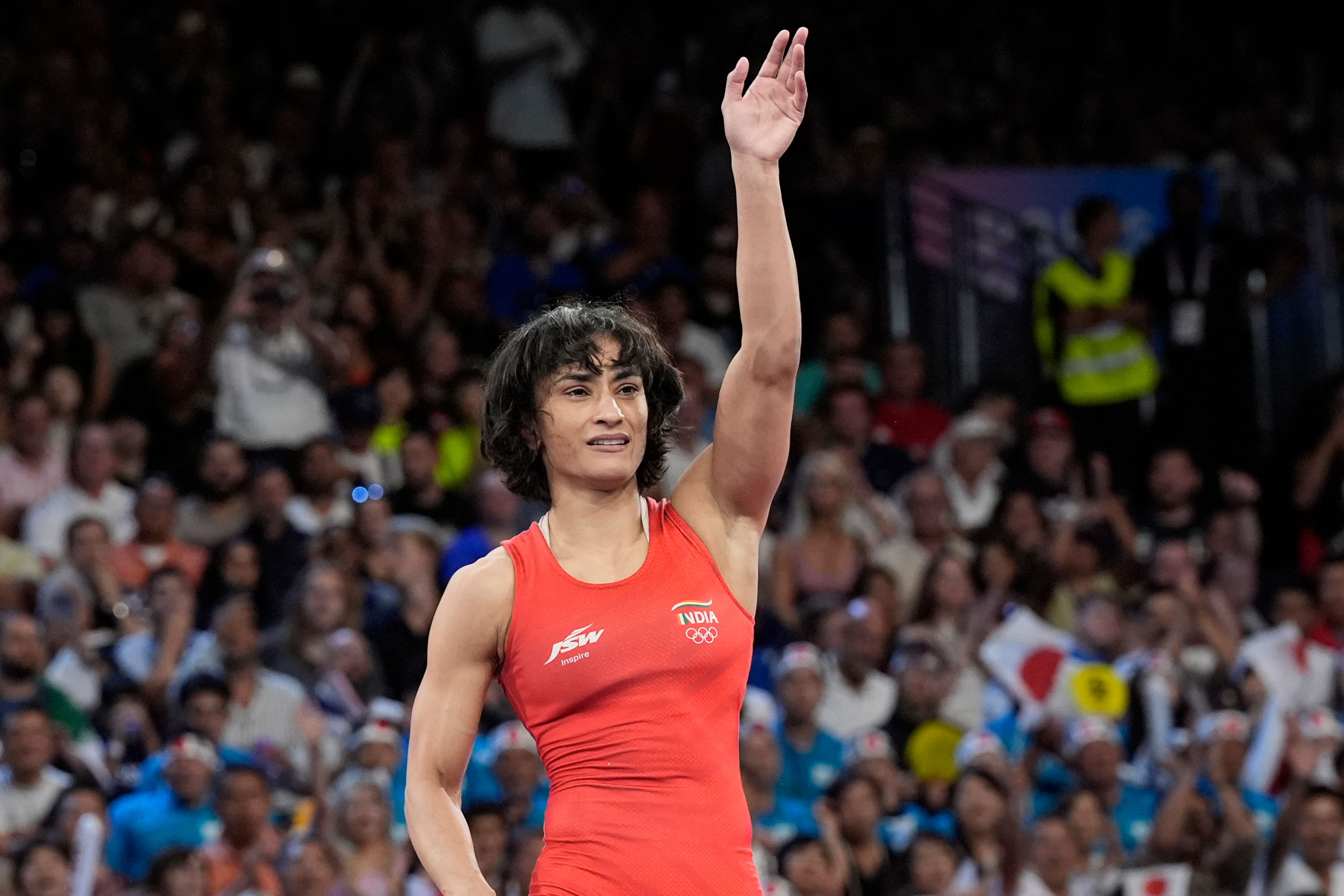 India's Vinesh Vinesh celebrates after defeating Cuba's Yusneylys Guzman during their women's freestyle 50kg wrestling semifinal match, at Champ-de-Mars Arena, during the 2024 Summer Olympics, Tuesday, Aug. 6, 2024, in Paris, France. (AP Photo/Eugene Hoshiko)