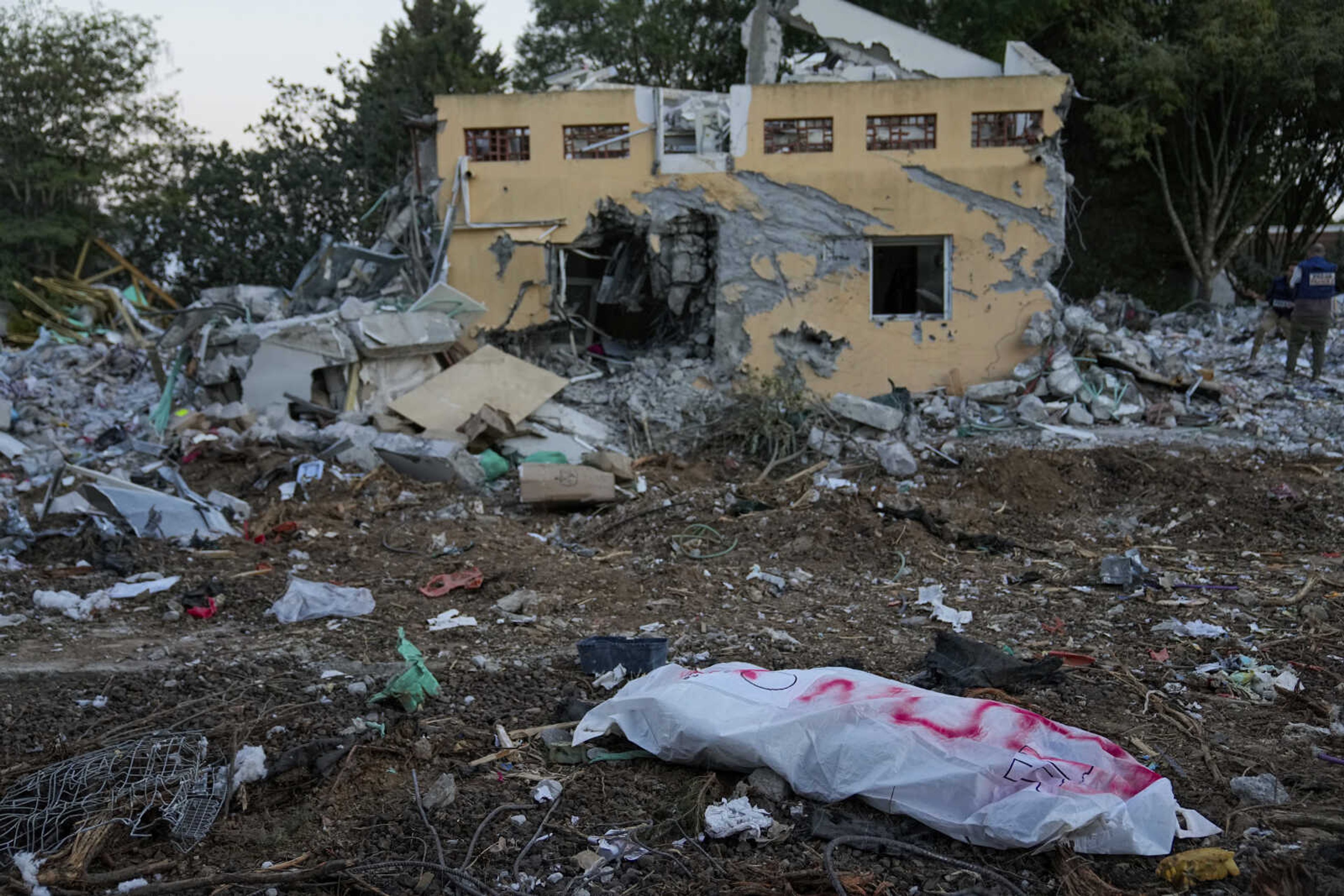 A Hamas militant in a body bag is seen Wednesday in Kibbutz Be'eri, Israel.