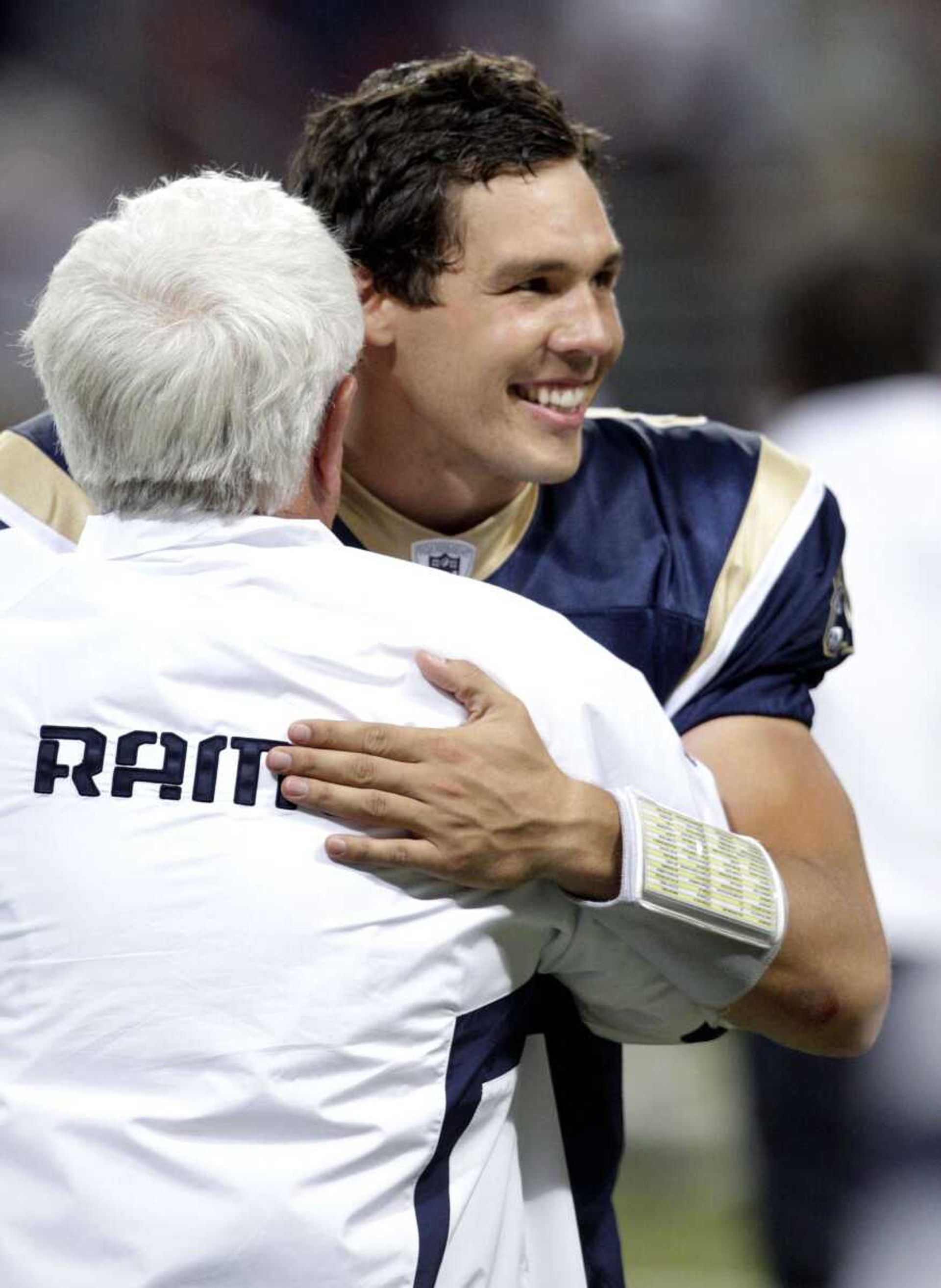 Rams quarterback Sam Bradford gets a hug from quarterbacks coach Richard Curl after St. Louis' 30-16 victory Sunday against the Redskins in St. Louis. (Tom Gannam ~ Associated Press)