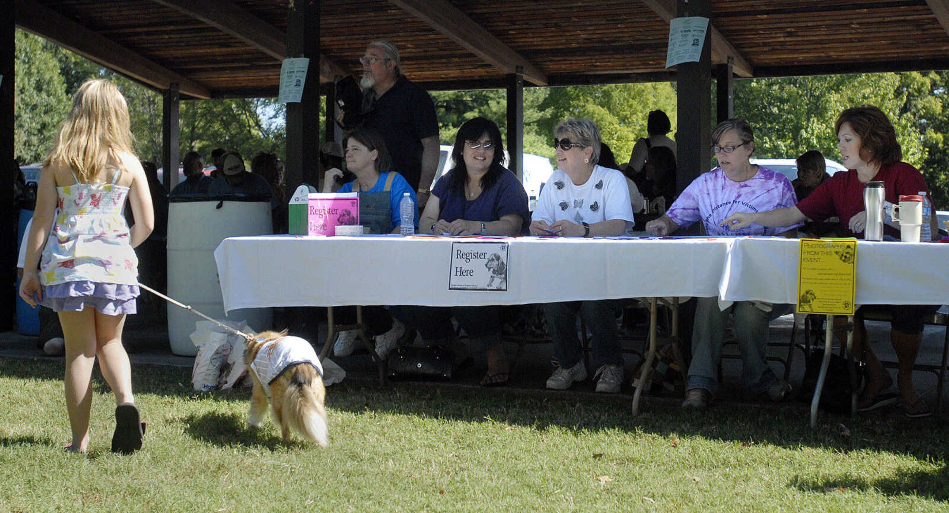 LAURA SIMON~lsimon@semissourian.com
Judges start their deliberation as Julie Buford walks away with her sheltie Hudson during the super heroes comstume contest Saturday, September 25, 2010 during Bark in the Park at Kiwanis Park in Cape Girardeau.