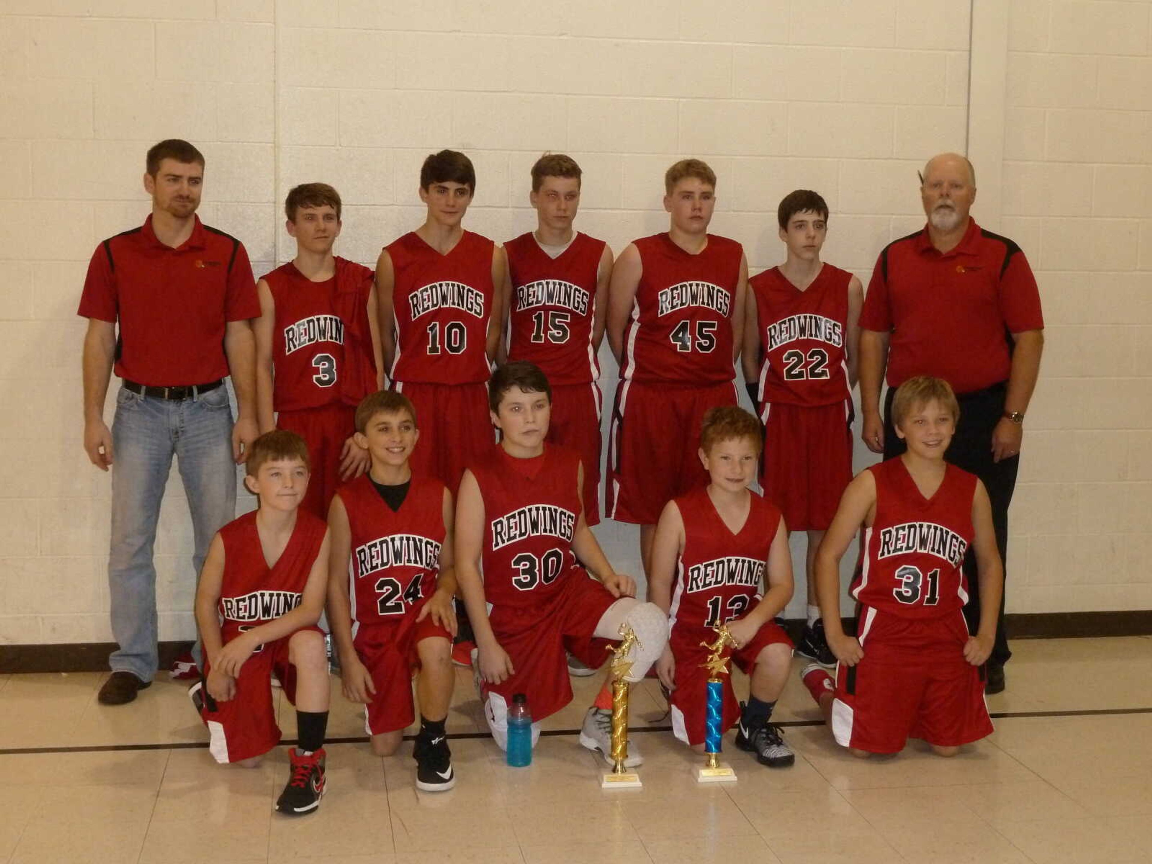 Guardian Angel Varsity Boys Basketball team with their 1st place tournament trophy and 1st place co-champion 2016 Christian League trophy.  Pictured are:  Front row (l-r):  Lawson Hahn, Riley Schlosser, Evan Montgomery, Drew Pobst, & Connor Watkins.  Back row (l-r):  Asst. Coach Andrew Hulshof, Cooper Priggel, Myles Trankler, Logan Rose, John Crippen, Langdon Scheeter, & Coach Kent Mangels.  Not pictured are Nathaniel Woods and Kyle Eftink.