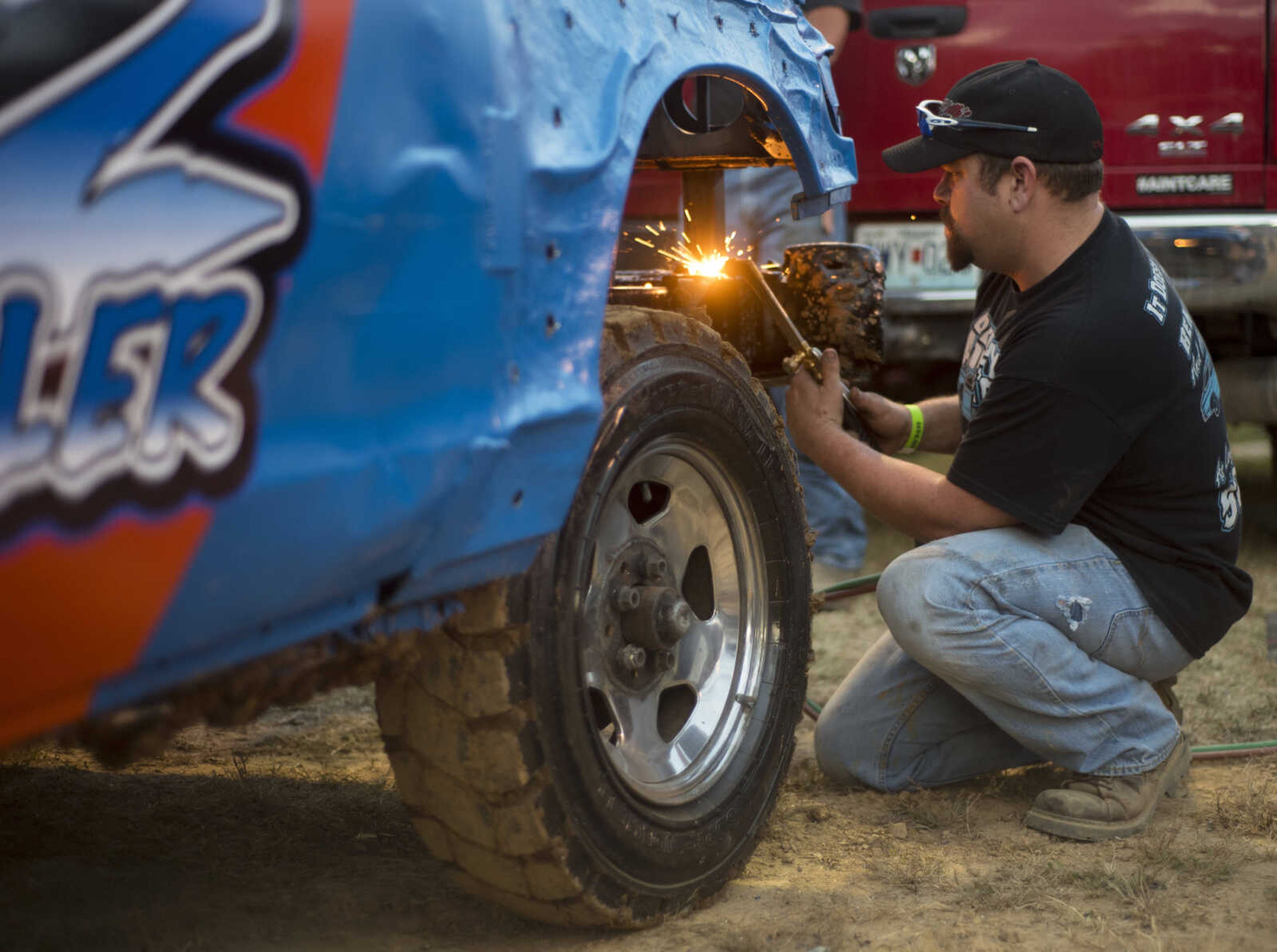 Chris Berkbigler makes last minute modifications to his car before the Auto Tire & Parts Dual Demo Derby September 9, 2017, at the SEMO District Fair in Cape Girardeau.