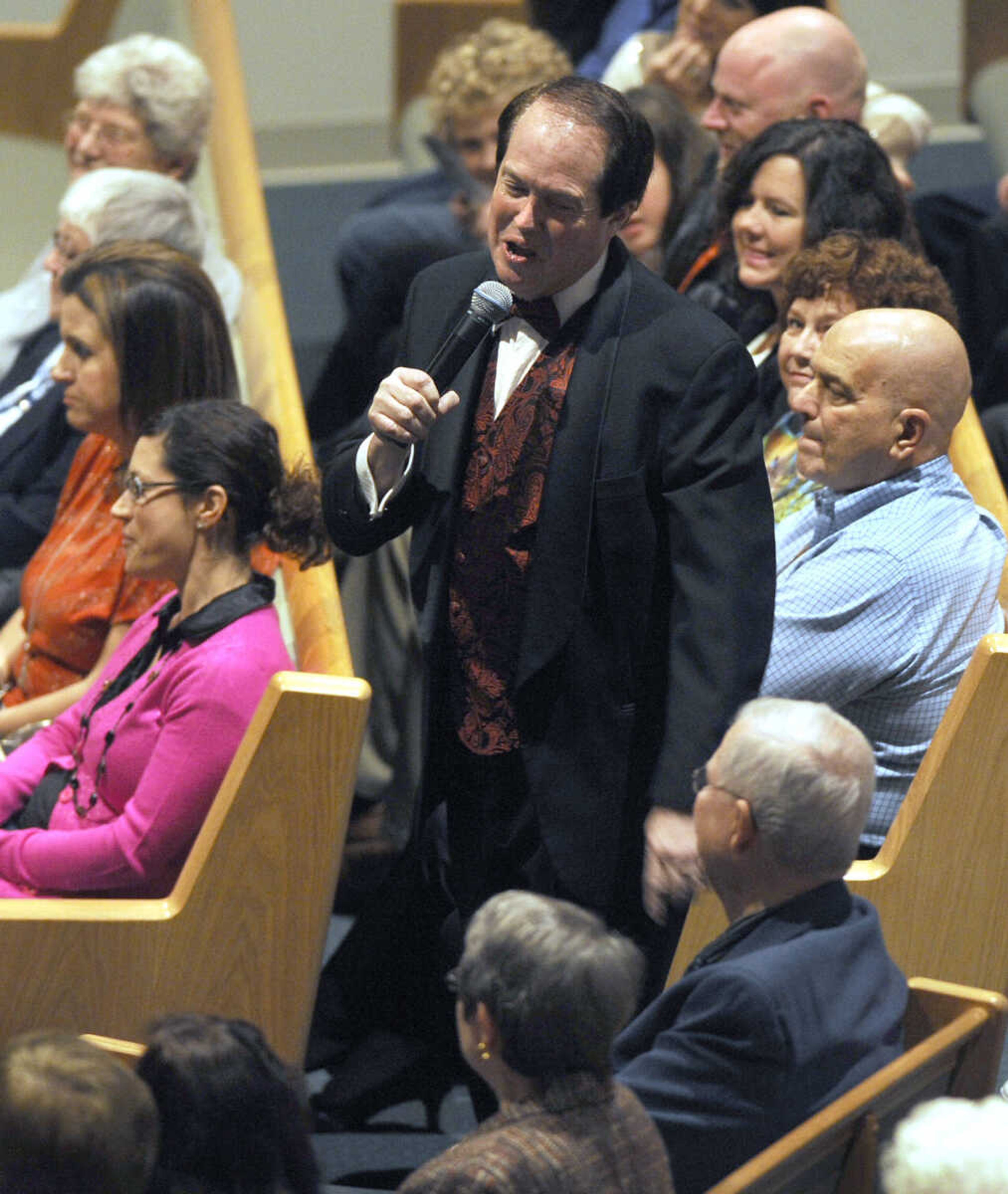 Mike Dumey sings in the audience at the Sounds of the Season Christmas concert.