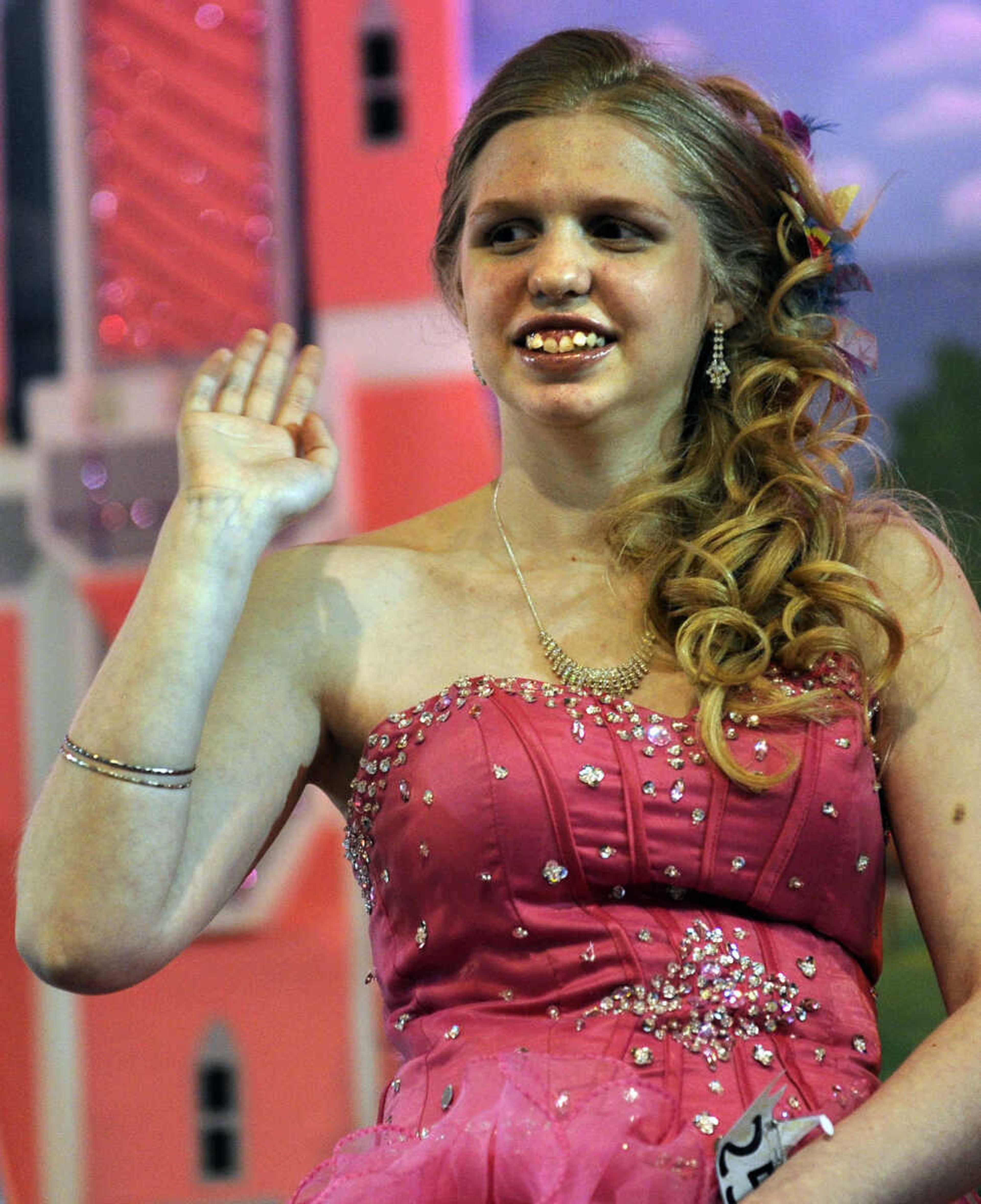 Summer Mason waves to the crowd in the 15-19 age division of the S. E. Missouri Angels Pageant on Saturday, April 26, 2014 at Scott City High School.