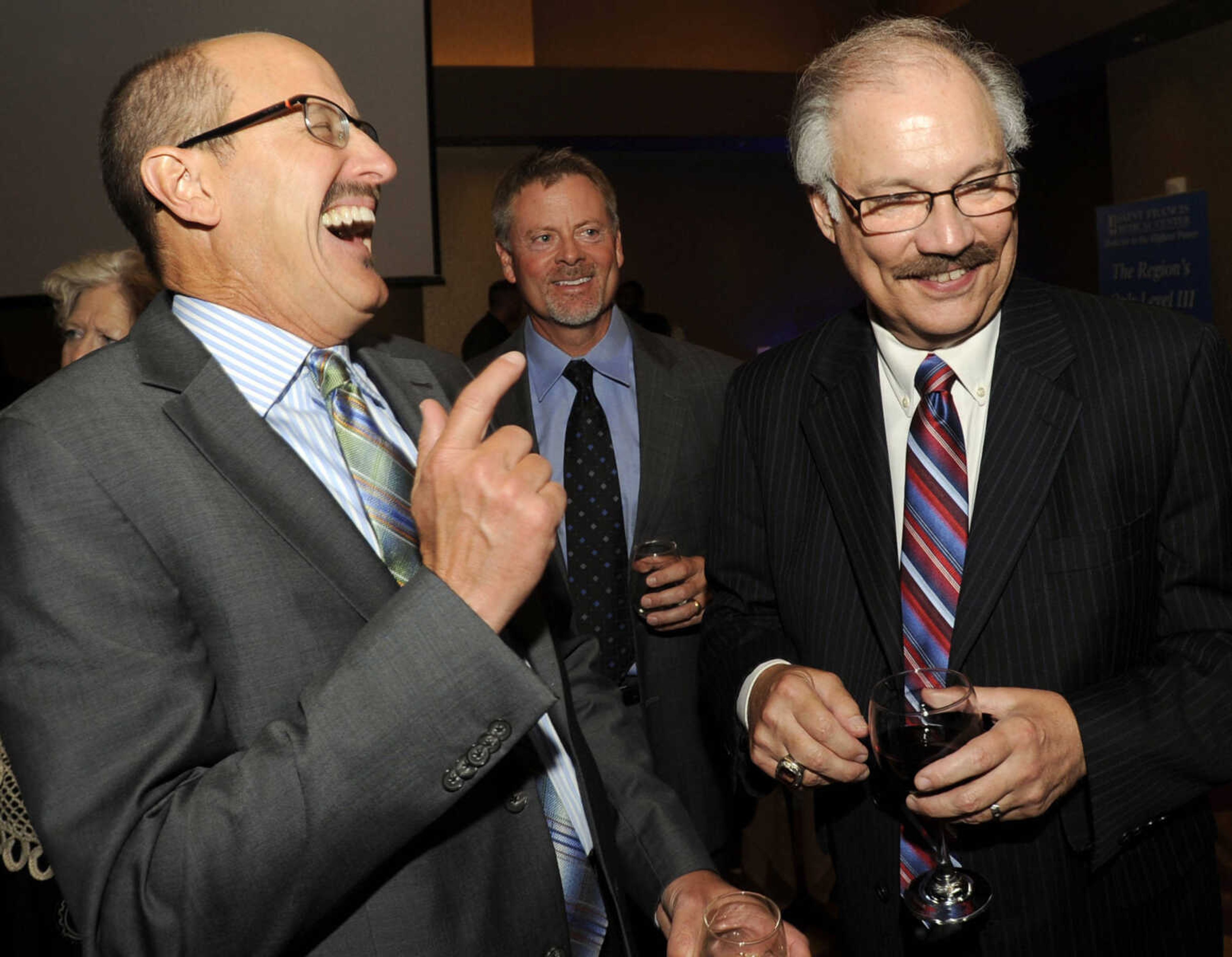 FRED LYNCH ~ flynch@semissourian.com
Dr. Jon Foley, left, laughs with Steven C. Bjelich at a retirement reception for Bjelich Thursday, Aug. 17, 2017 at Isle Casino Event Center.