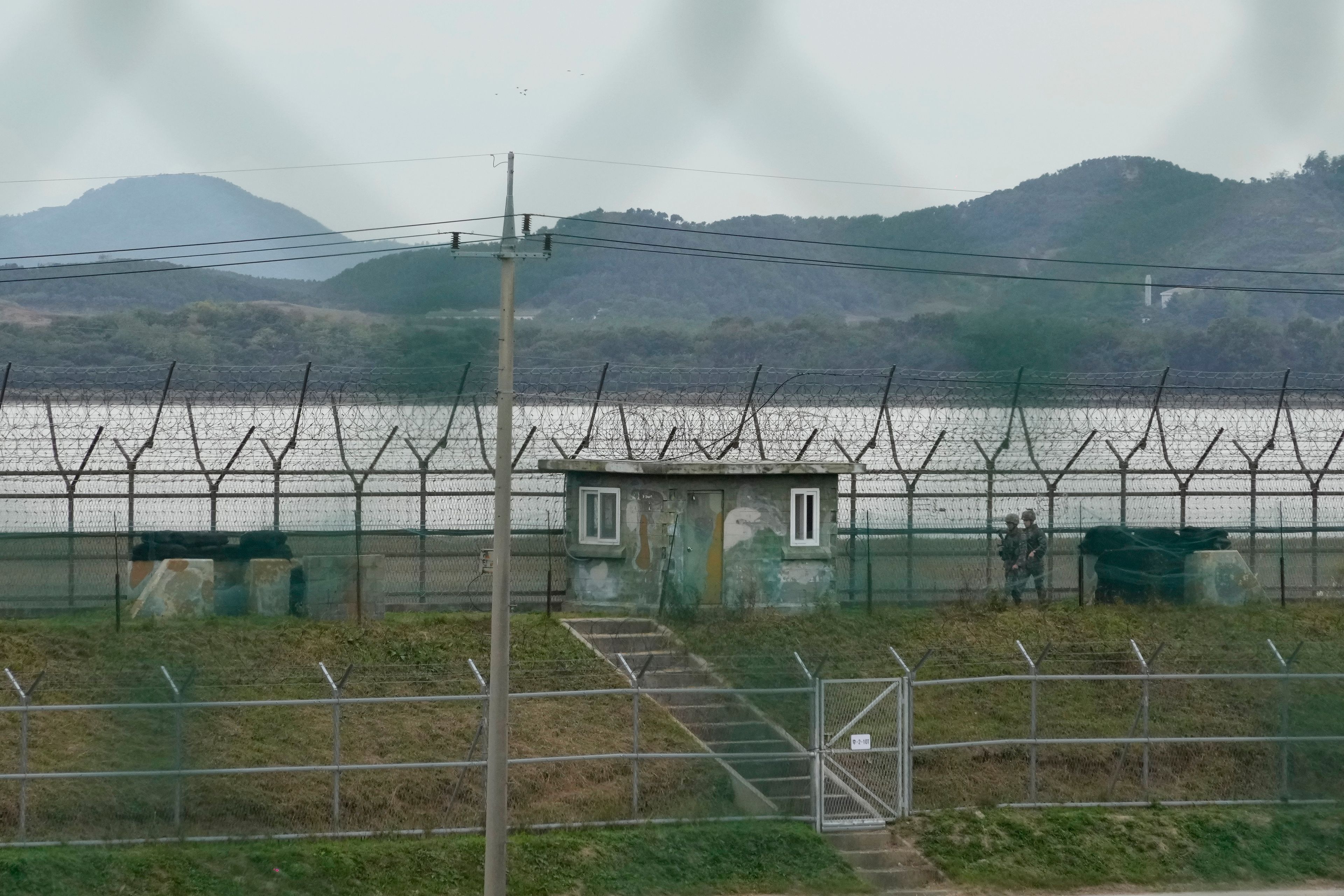 South Korean army soldiers patrol along the barbed-wire fence in Paju, South Korea, near the border with North Korea, Monday, Oct. 14, 2024. (AP Photo/Ahn Young-joon)