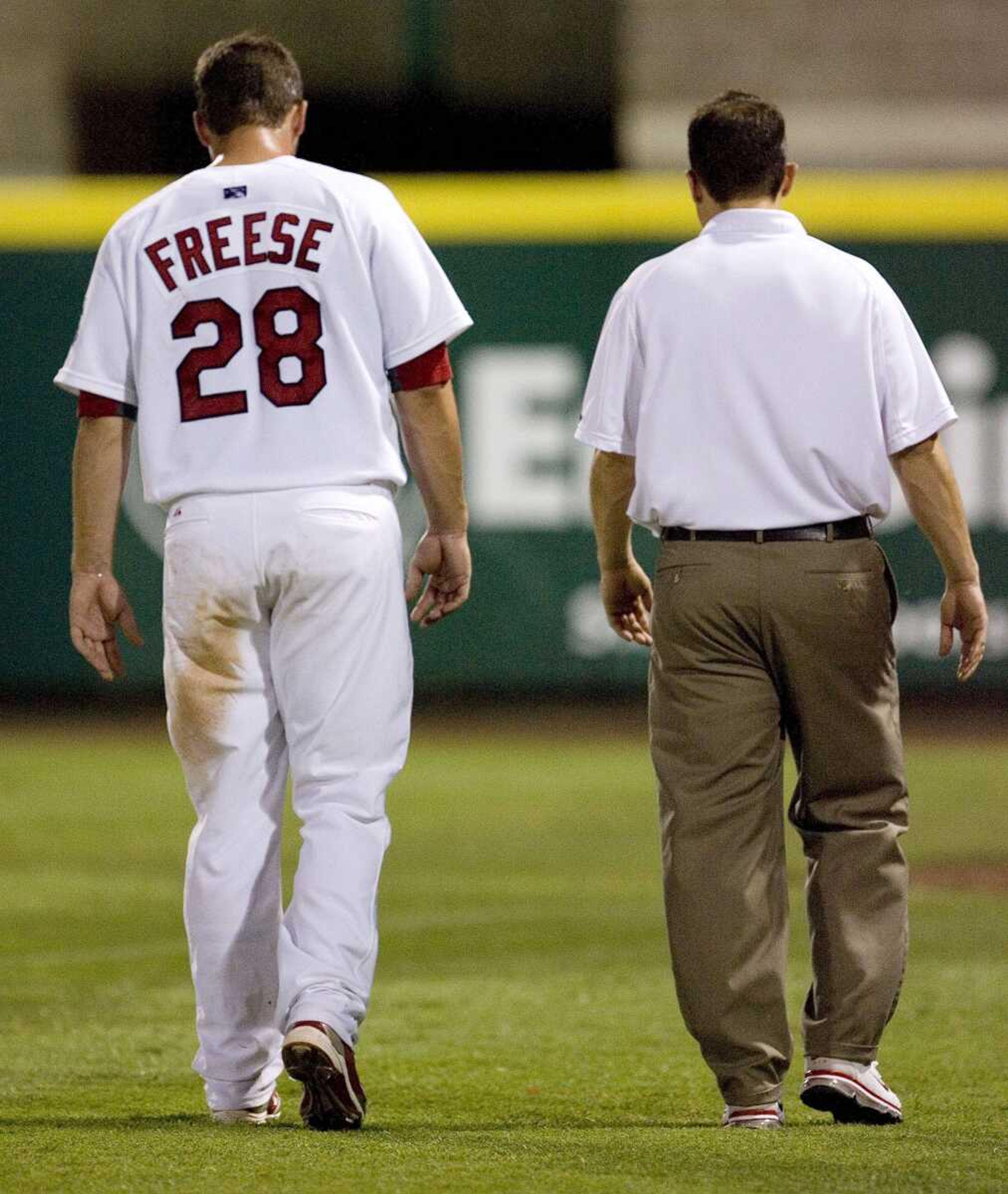 <b>Nathan Papes </b>Springfield News-Leader (The Cardinals' David Freese limps off the field Monday with Springfield Cardinals trainer Jay Pierson after being injured in a Class AA game in Springfield, Mo. Freese re-injured his right ankle in the rehabilitation start and is lost for the season.)