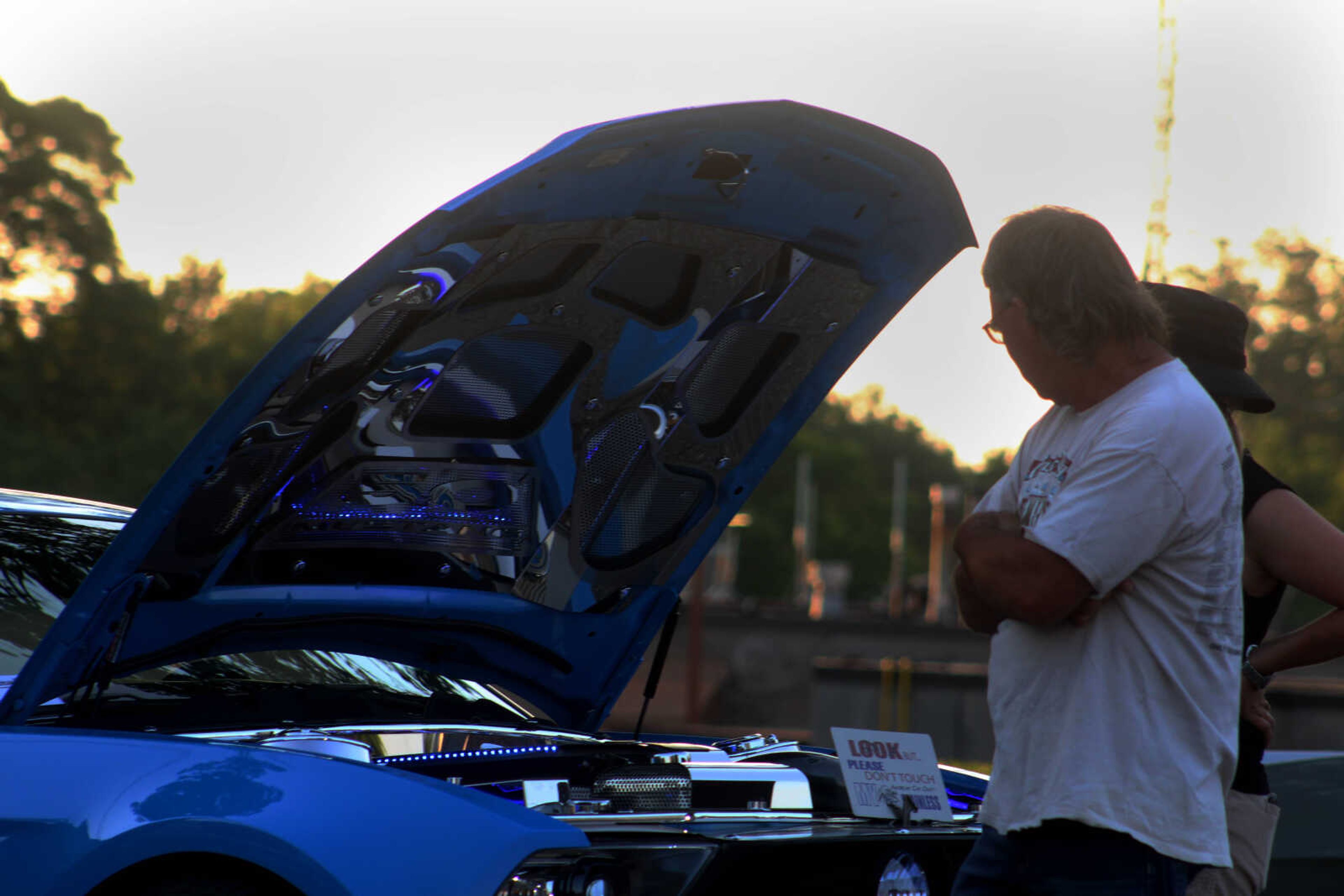 Community members look under the hood of antique cars, hot rods, customs and bikes at the Cruisin Uptown Car Show on Saturday, June 13, at 101 Court Street in Jackson.