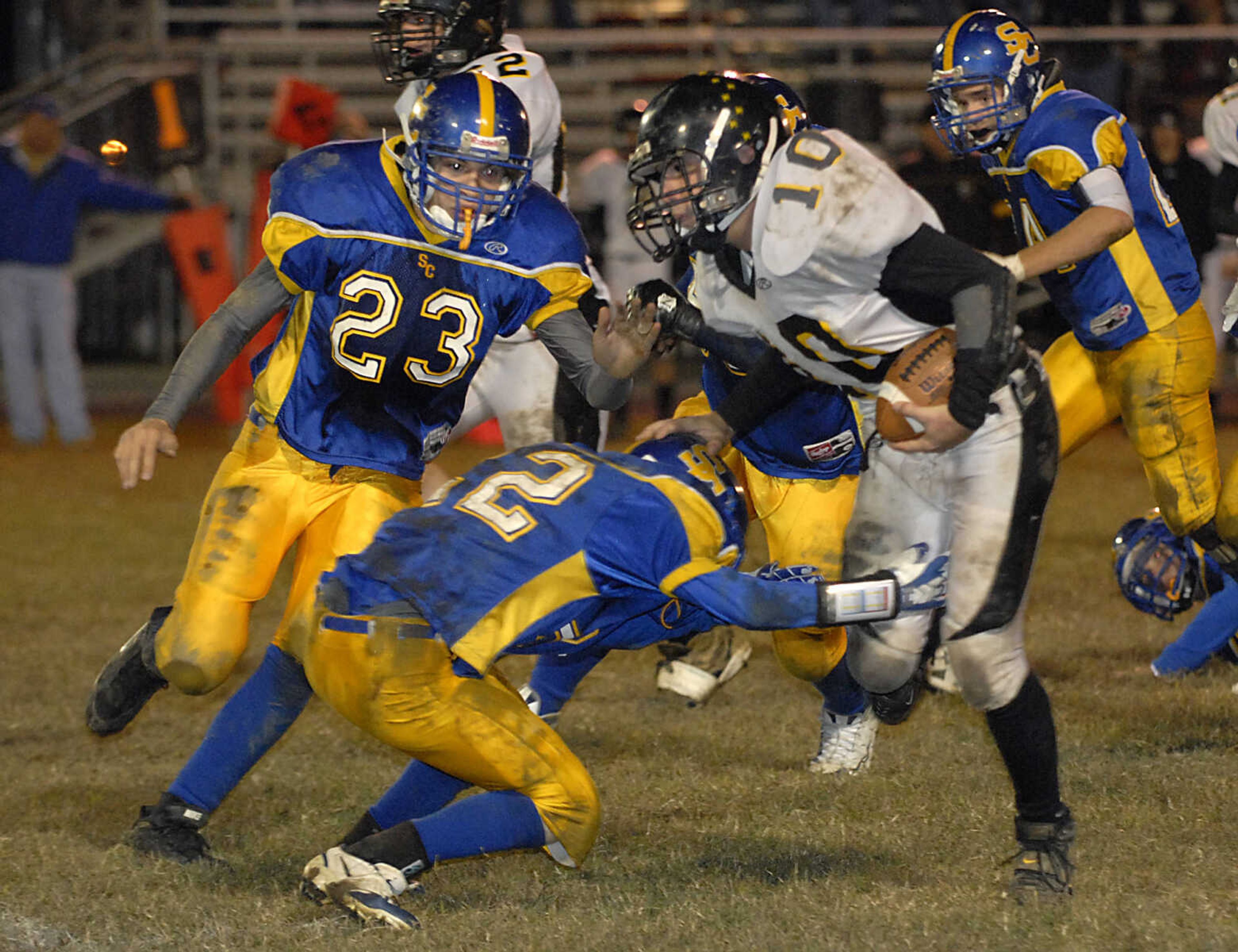 KIT DOYLE ~ kdoyle@semissourian.com
Scott City defenders Todd Morrison (23) and Garrett Schaefer combine to tackle Grandview running back Robby Allen Friday, October 16, 2009, in Scott City.