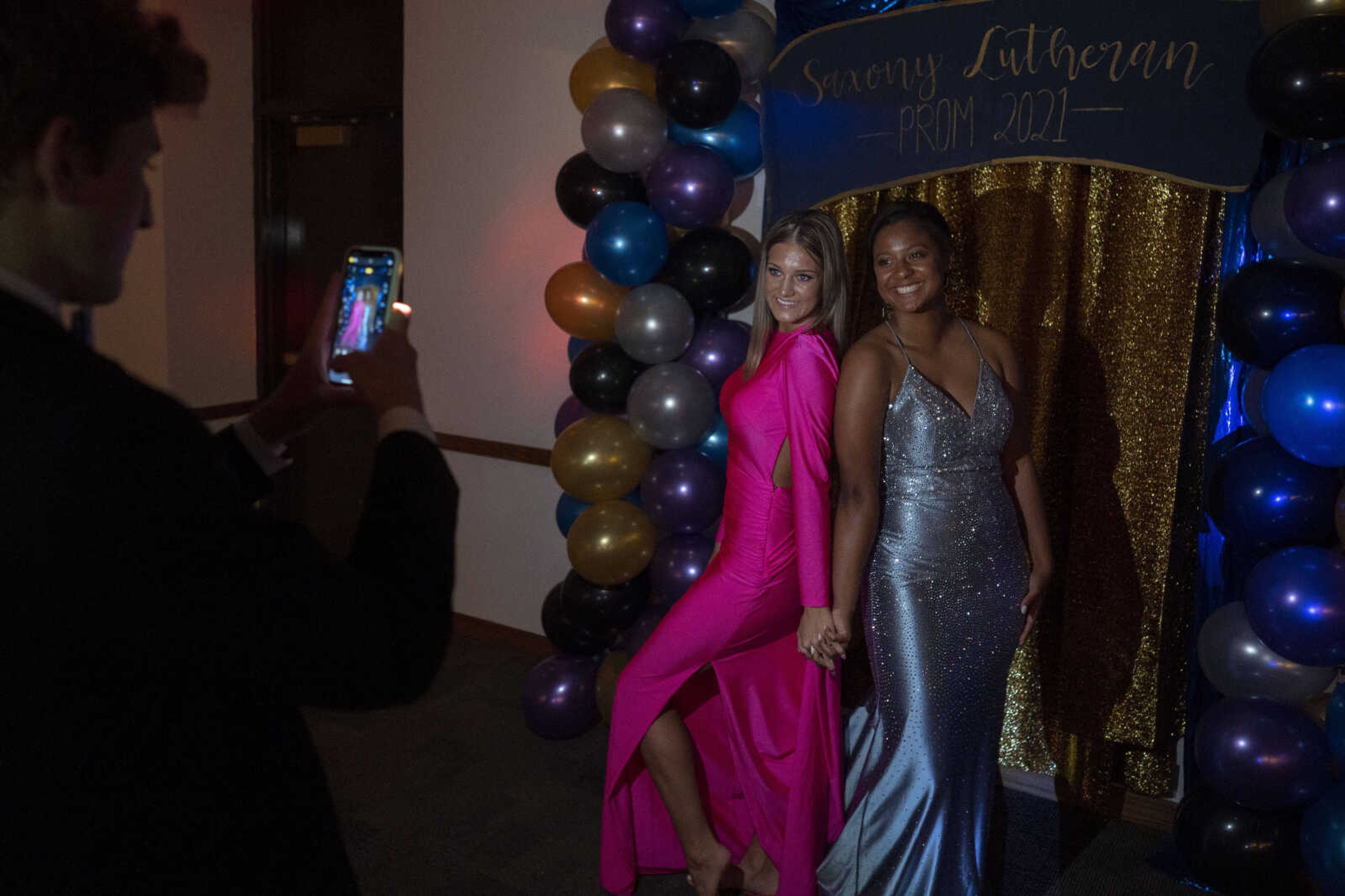 Ty Seabaugh, far left, photographs Maddox Murphy, center, and Sydney Turner, right, during the Saxony Lutheran prom Saturday, April 26, 2021, at  the Elks Lodge in Cape Girardeau.