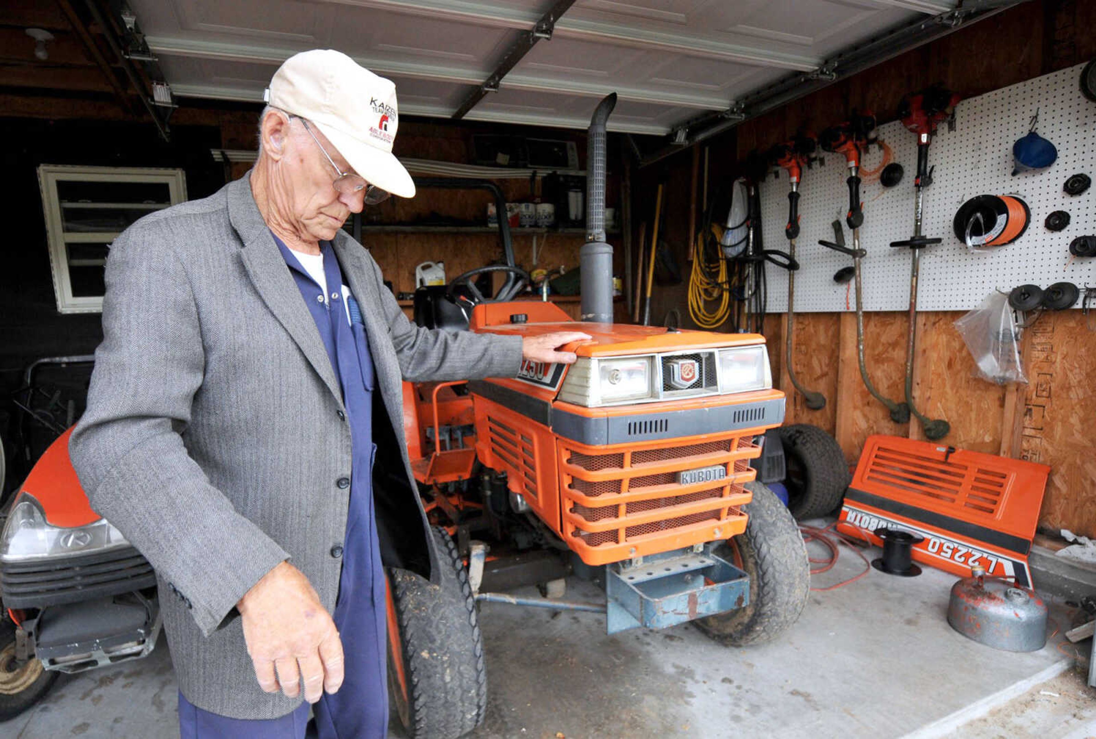 Carl Junction Cemetery volunteer Art Maddox stands in one of the garages housing mowers for upkeep of the cemetery in Carl Junction, Missouri. Although he is no longer caretaker for the cemetery, Maddox still lends a hand helping with upkeep of the cemetery, which is operated solely through private donations. (Laurie Sisk ~ The Joplin Globe)