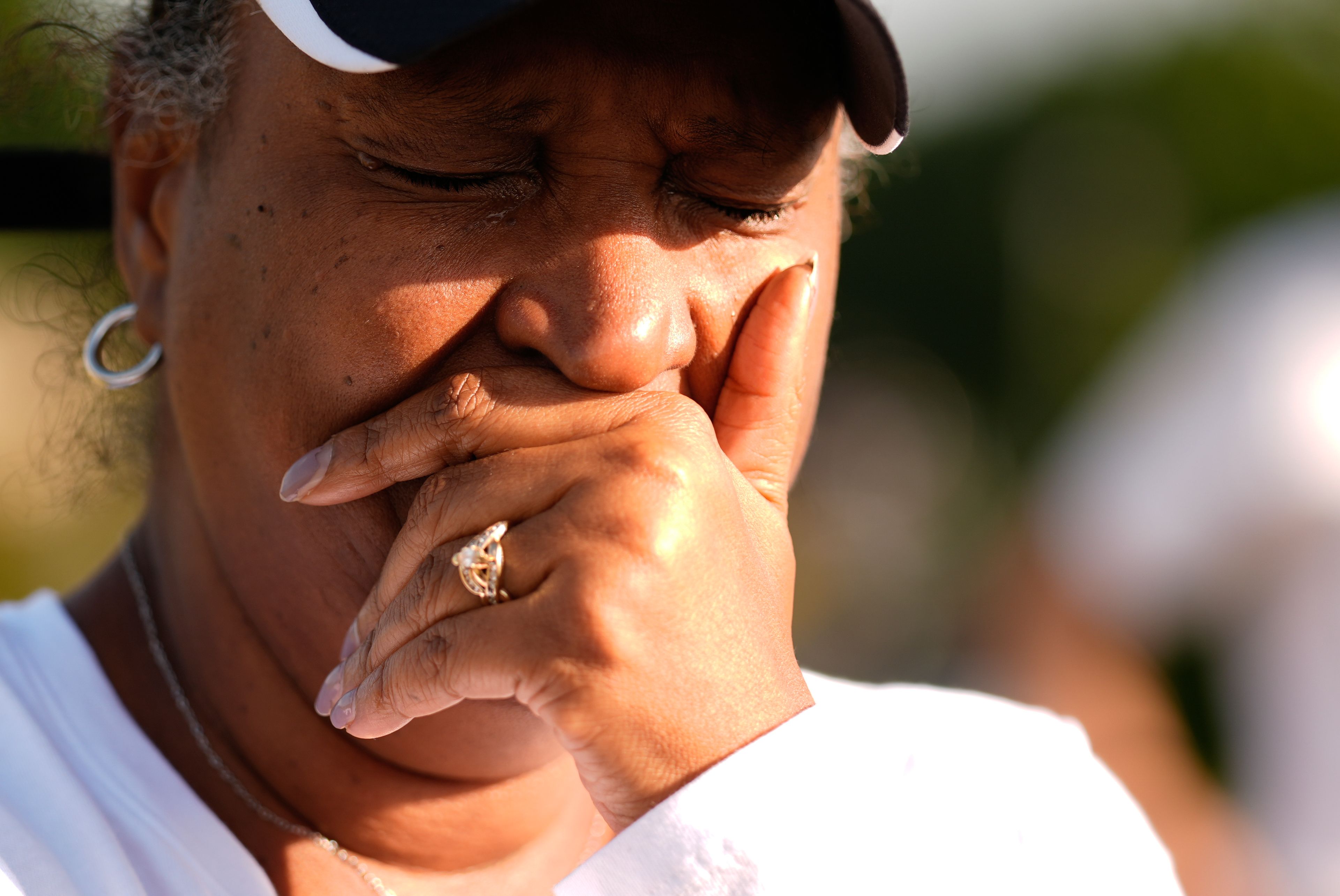 Chimain Douglas, of Grayson, Ga., cries near Apalachee High School as she mourns for the slain students and teachers on Thursday, Sept. 5, 2024, in Winder, Ga. (AP Photo/Brynn Anderson)