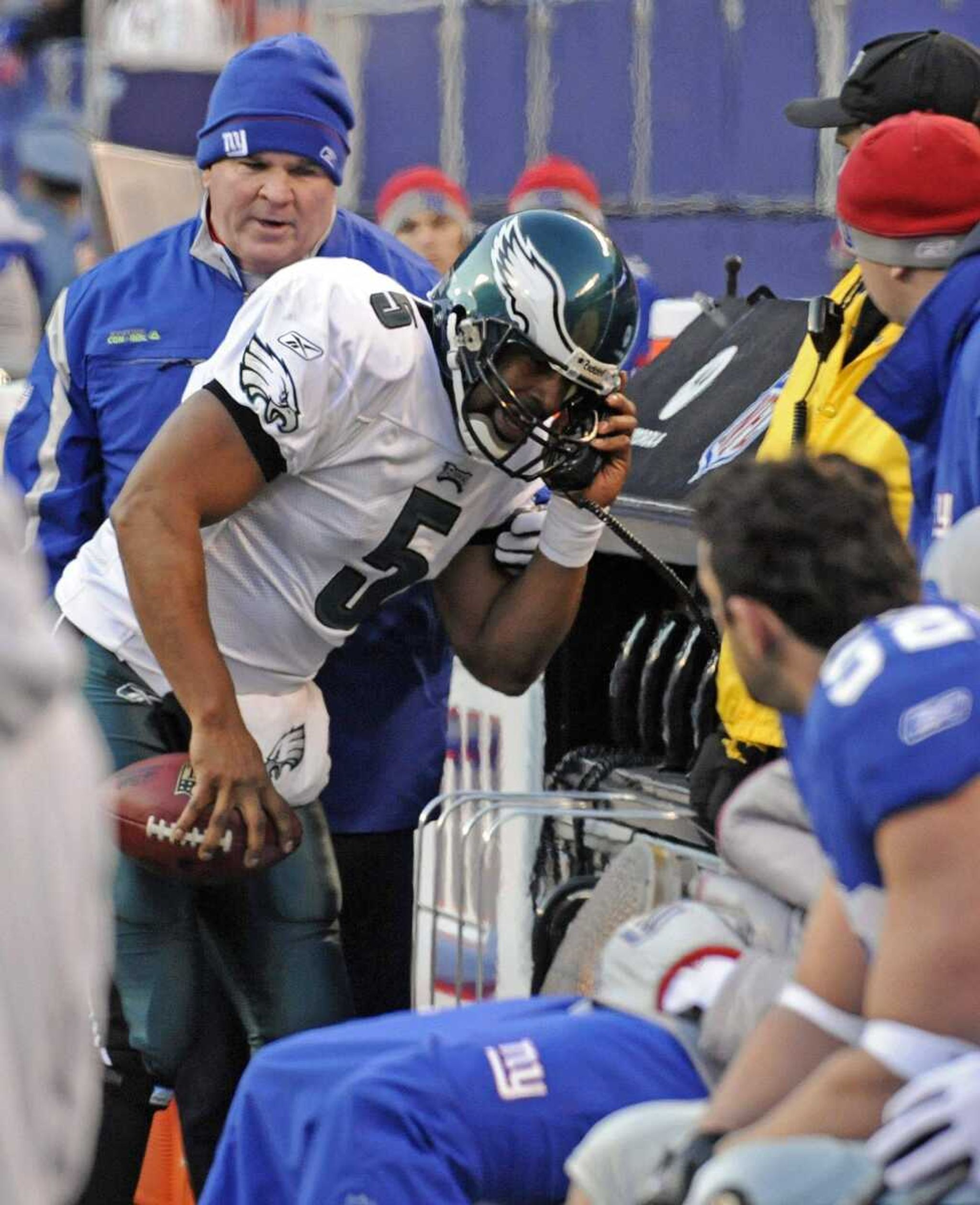 Philadelphia Eagles quarterback Donovan McNabb (5) picks up a phone by the New York Giants bench after running out of bounds during the fourth quarter of an NFL divisional football playoff game Sunday, Jan. 11, 2009, at Giants Stadium in East Rutherford, N.J. McNabb was called for an unsportsmanlike penalty on the play. (AP Photo/Bill Kostroun)