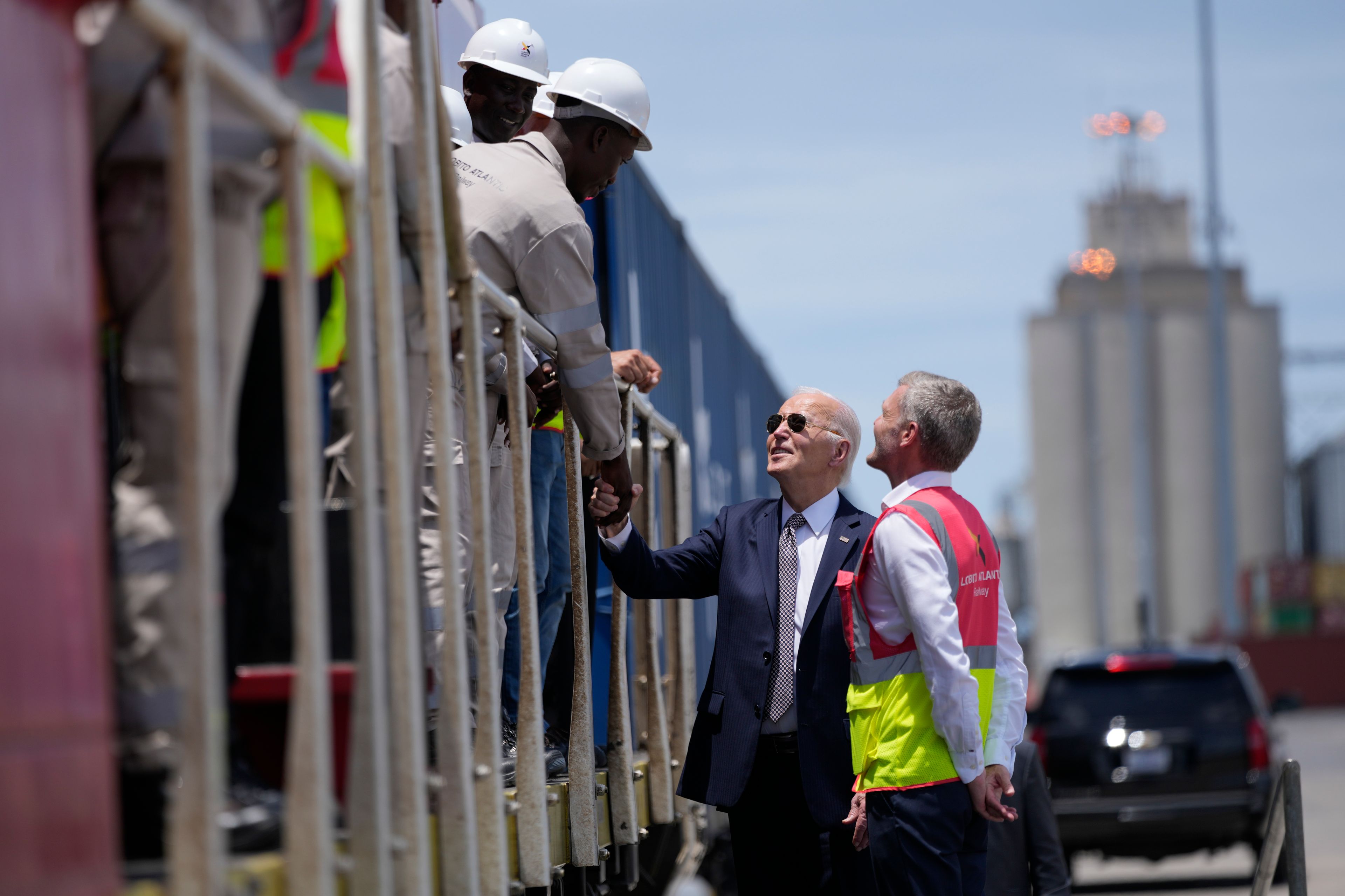 President Joe Biden and Chief Operating Officer of Lobito Atlantic Railway Nicolas Gregoire meet rail workers during the tour of the Lobito Port Terminal in Lobito, Angola, on Wednesday, Dec. 4, 2024. (AP Photo/Ben Curtis)