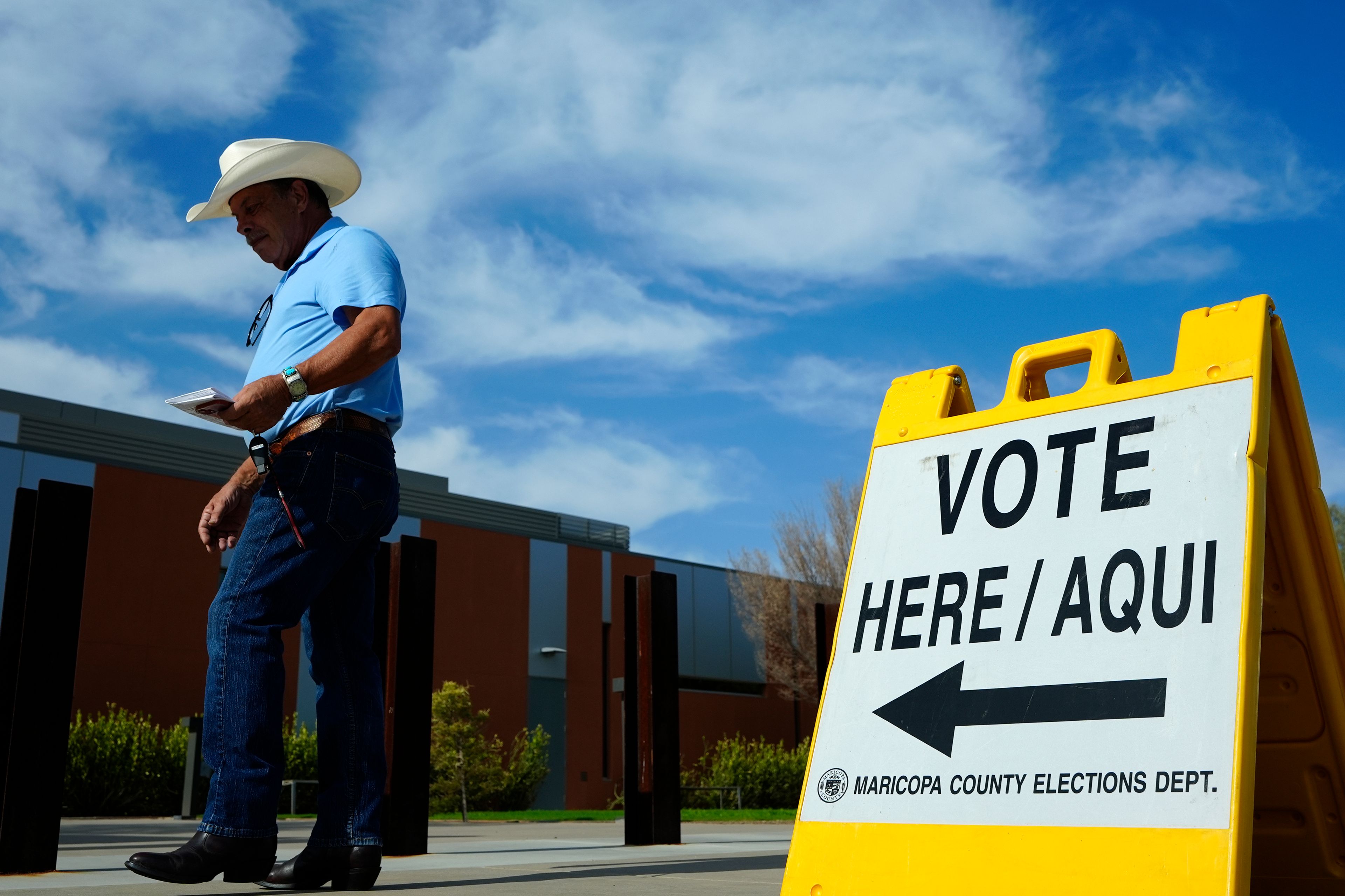 A voter walks to a voting precinct prior to casting his ballot in the state's primary election, Tuesday, July 30, 2024, in El Mirage, Ariz. (AP Photo/Ross D. Franklin)