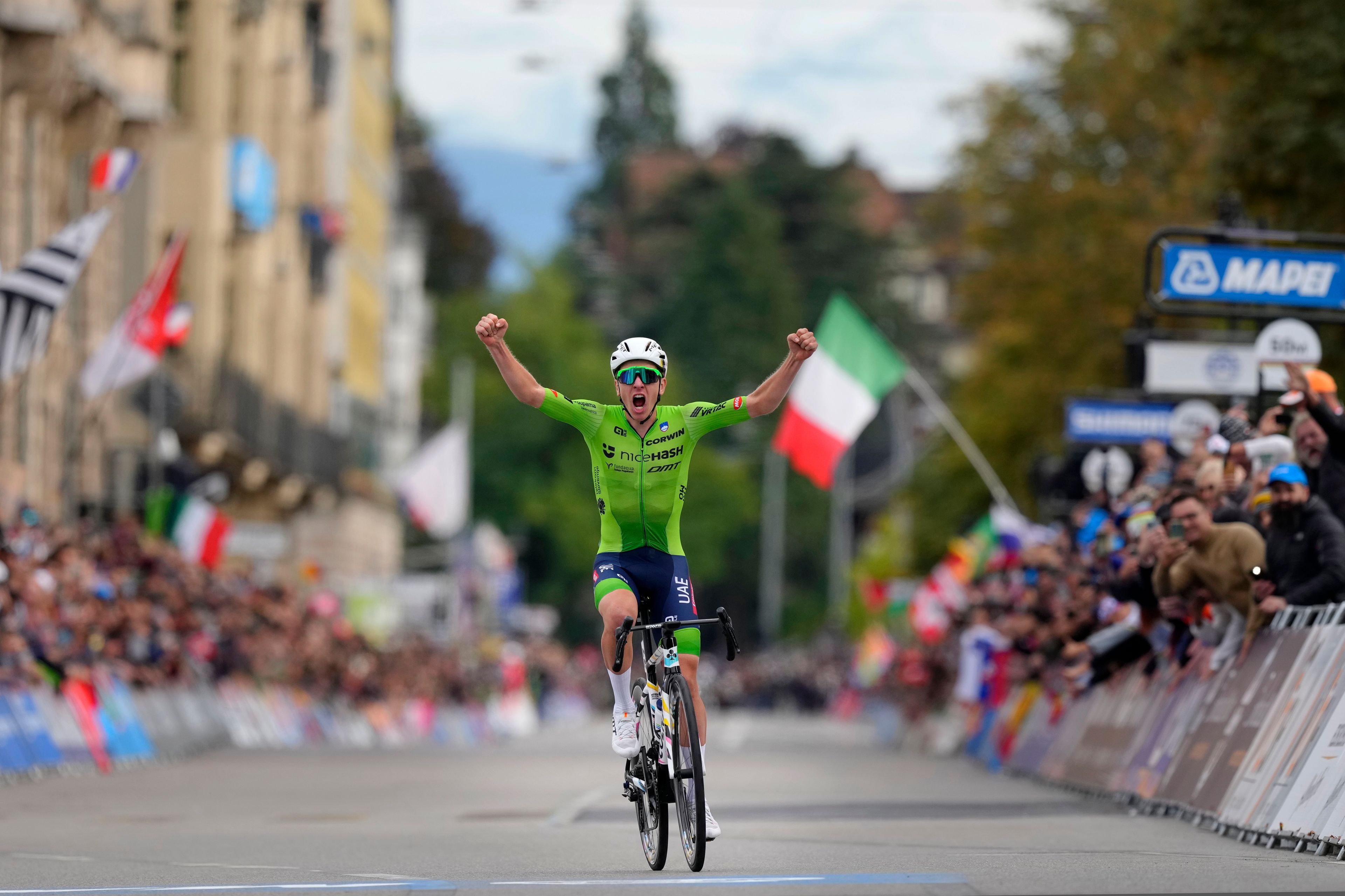 Slovenia's Tadej Pogacar crosses the finish line to win the Men Elite road race of the Cycling and Para-cycling Road World Championships in Zurich, Switzerland, Sunday, Sept. 29, 2024. (AP Photo/Peter Dejong)