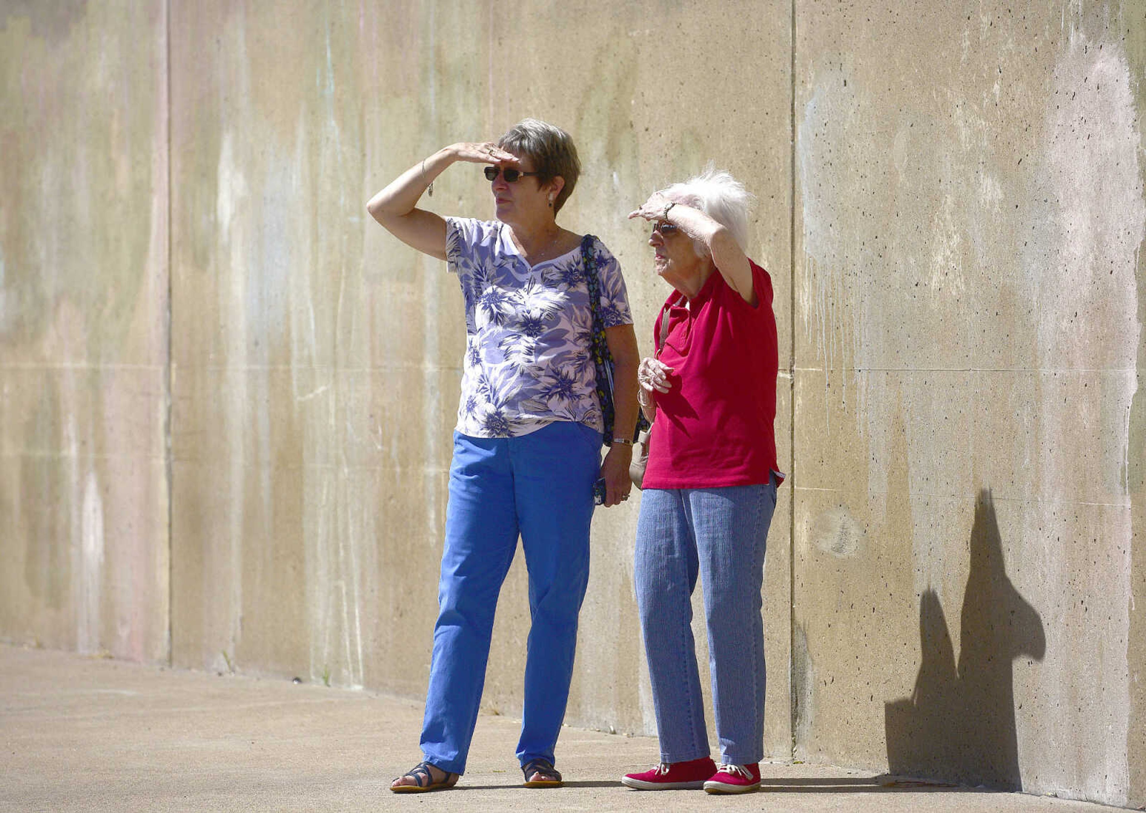 Mary Kay Kates, left, and Katie Stoner take in the view of Queen of the Mississippi and the American Queen while the riverboats were docked at Riverfront Park on Wednesday, Aug. 23, 2017, in downtown Cape Girardeau.