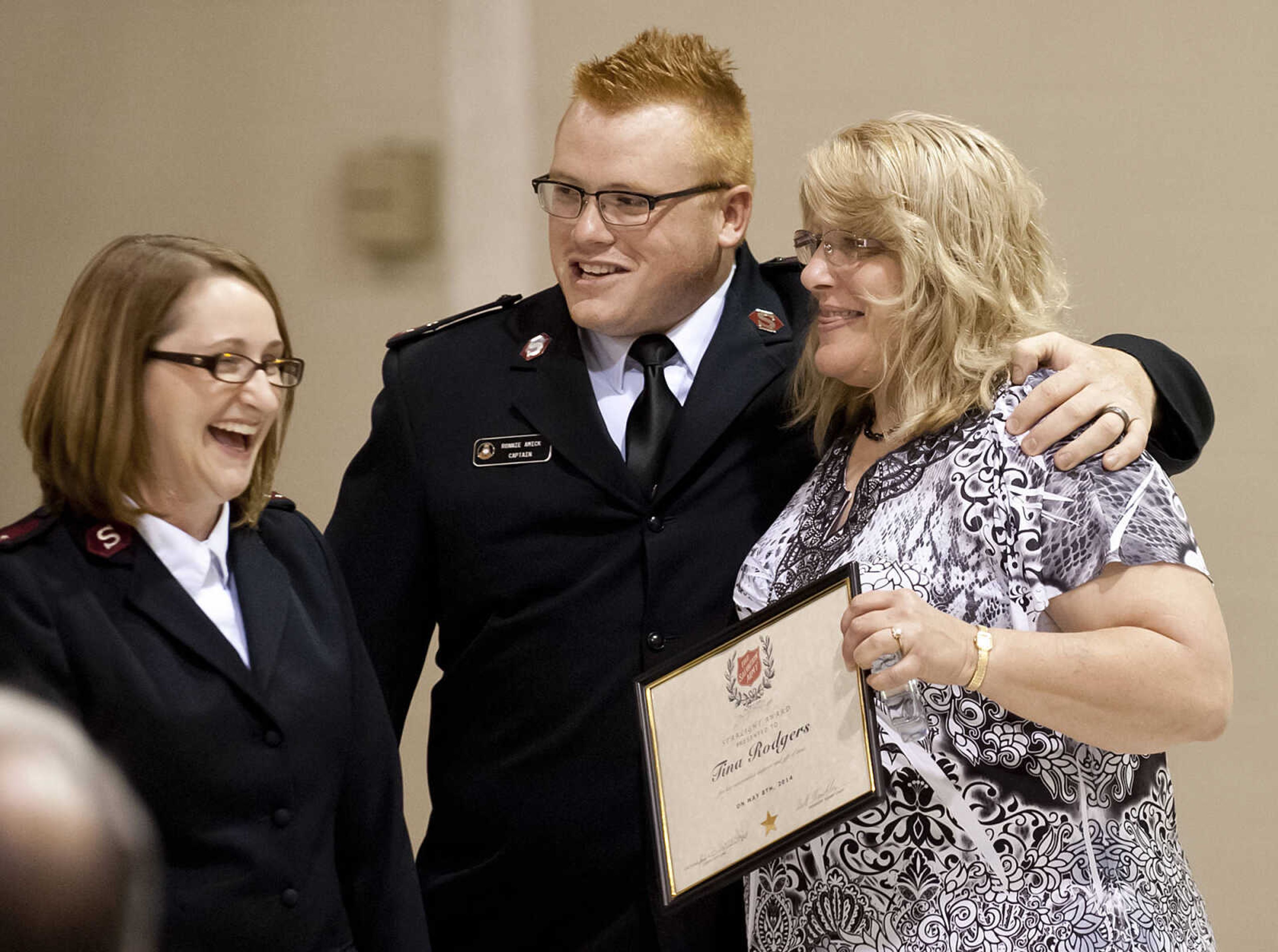 Captains Ronnie and Bridgette Amick with case worker Tina Rodgers after Rodgers was named the recipient of the Star Light Award during the Cape Girardeau Salvation Army's annual dinner, "A Night with the Stars," Thursday, May 8, at the Cape Girardeau Salvation Army.