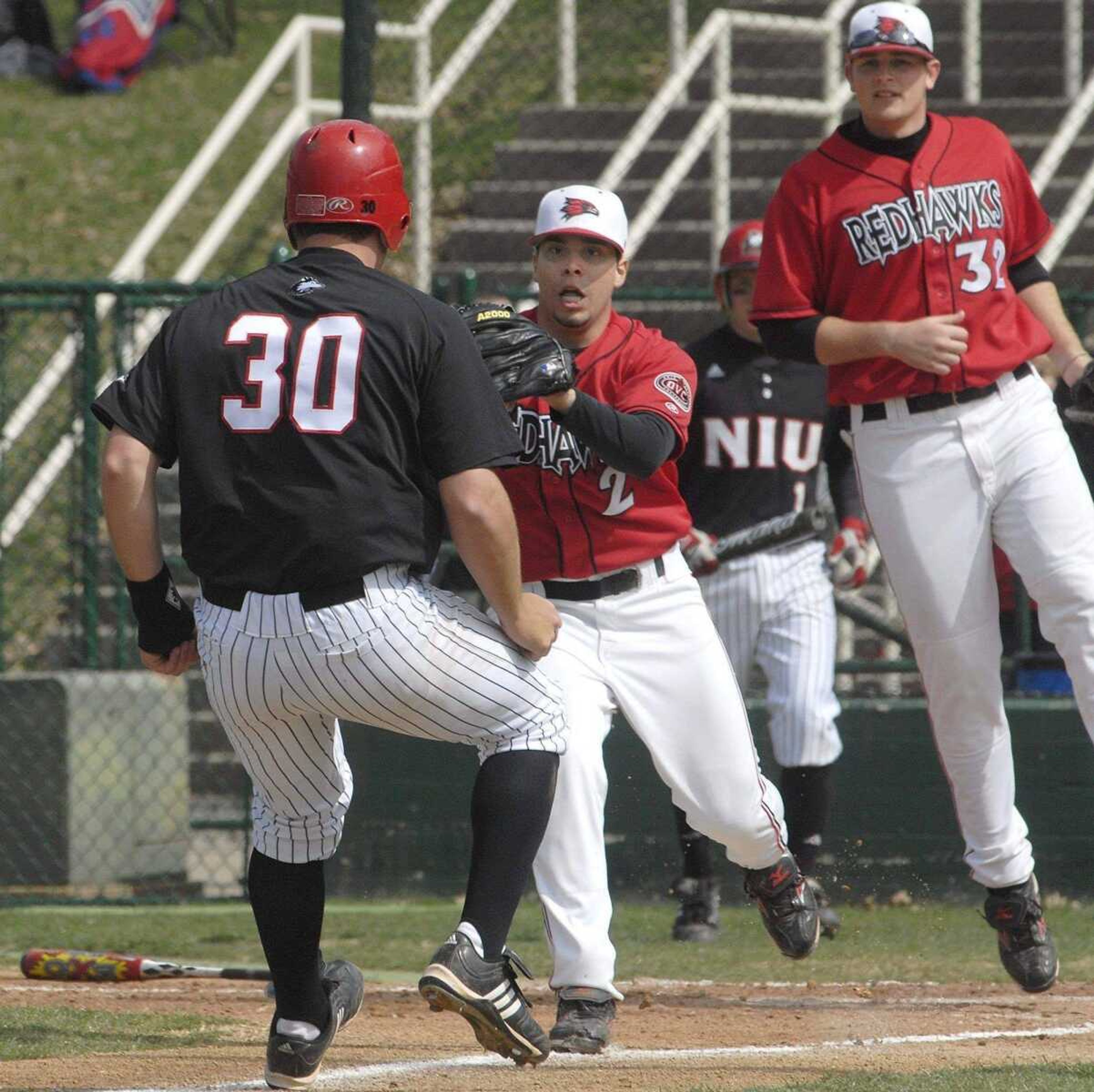 Southeast Missouri State pitcher John Salazar tags out Northern Illinois' Justin Behm in a rundown between home and third base during the third inning.