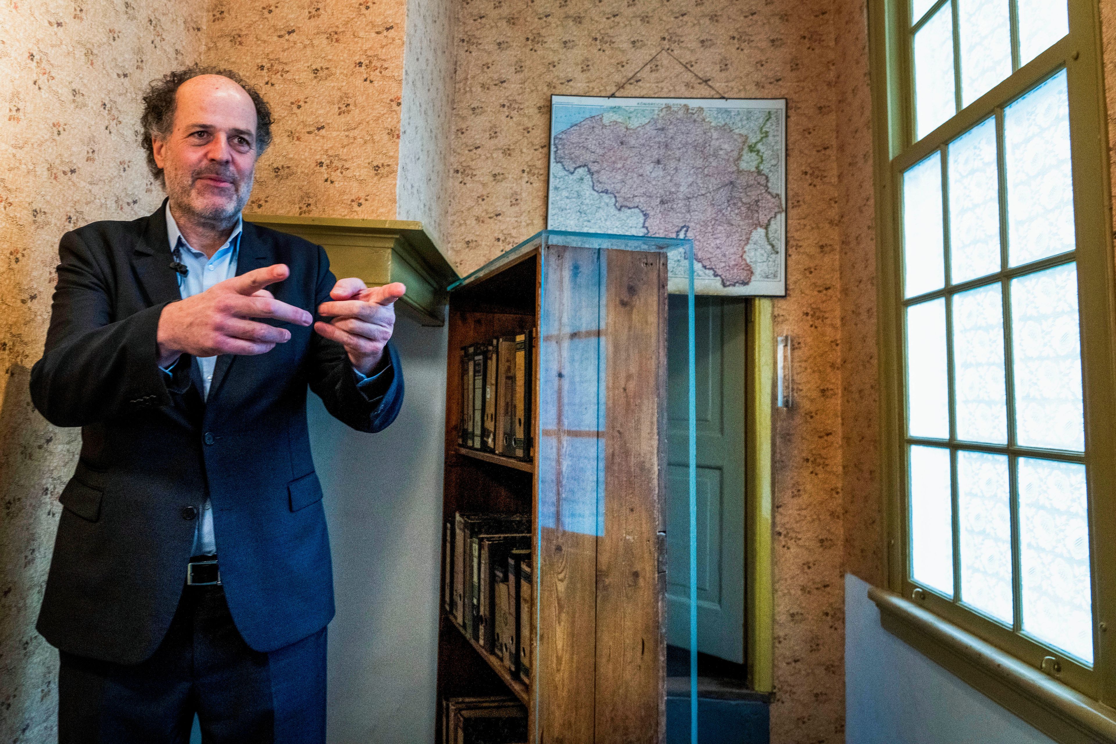 FILE - Ronald Leopold, executive director of the Anne Frank House, gestures as he talks next to the passage to the secret annex during an interview in Amsterdam, Netherlands, Monday, Jan. 17, 2022. (AP Photo/Peter Dejong, File)