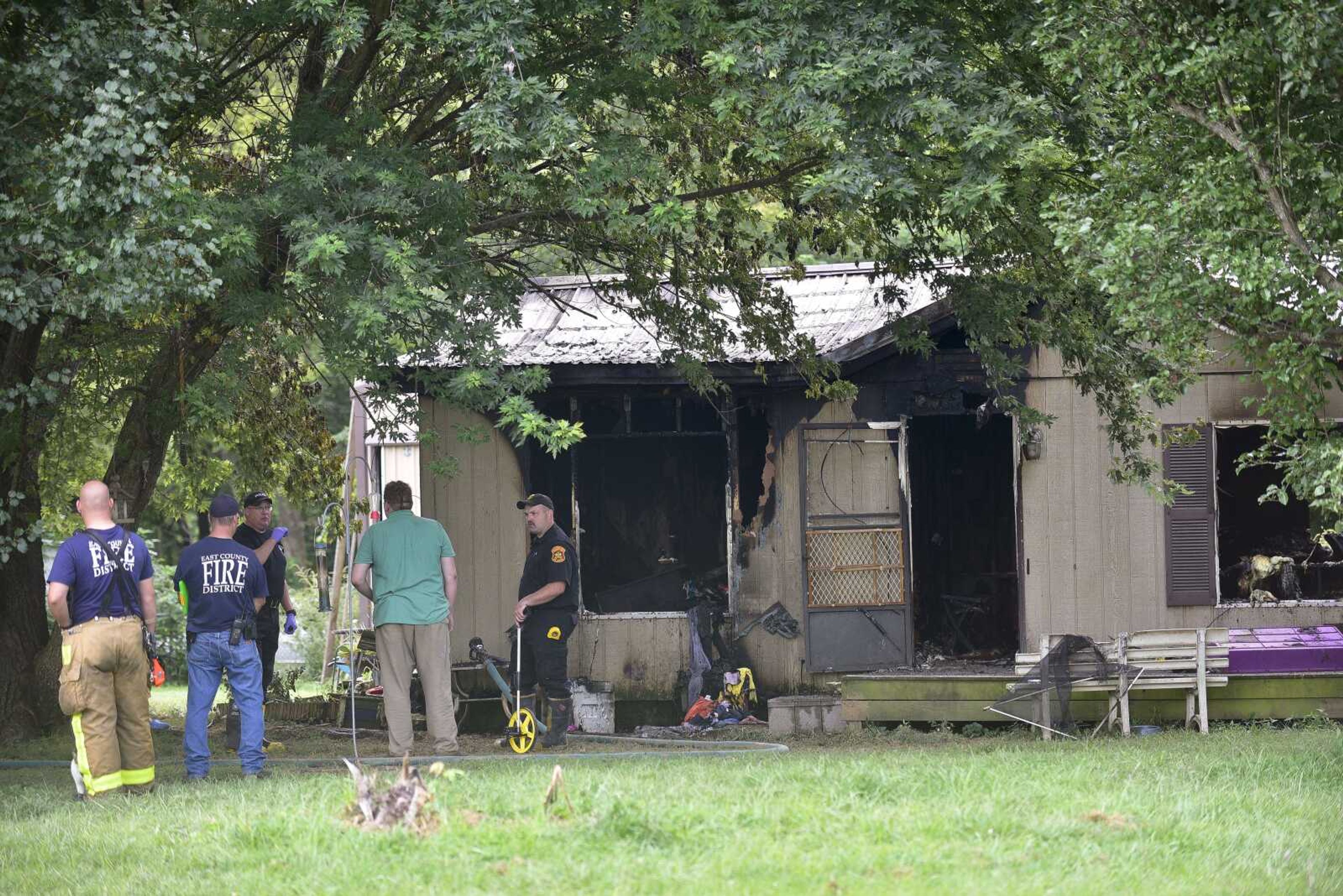 East County Fire Department firefighters investigate a house fire Tuesday on Route V in Cape Girardeau County.