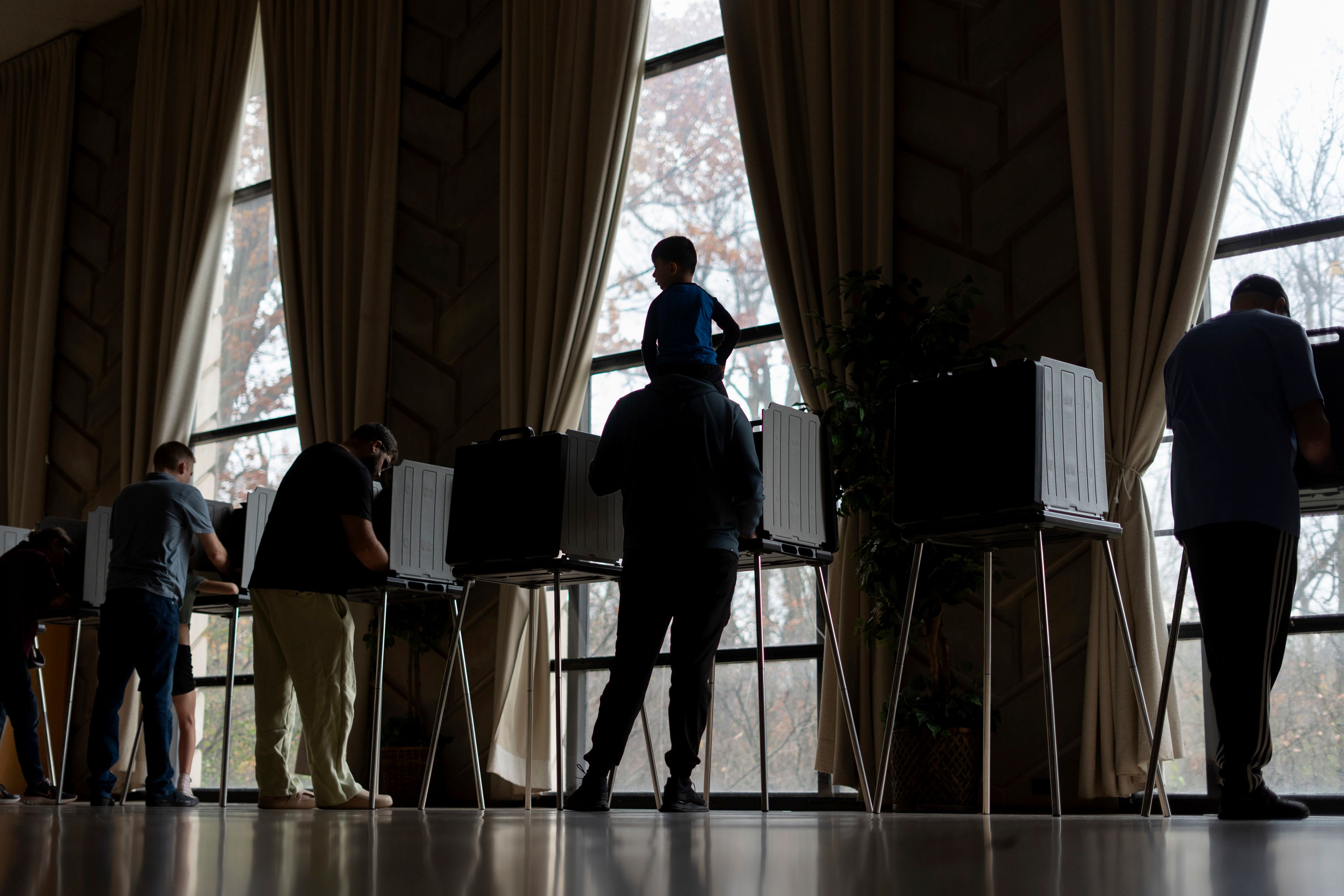 Three-year-old Zayn, sits on his father's shoulders as he votes at the First Presbyterian Church of Dearborn, on Election Day, Tuesday, Nov. 5, 2024, in Dearborn, Mich. (AP Photo/David Goldman)