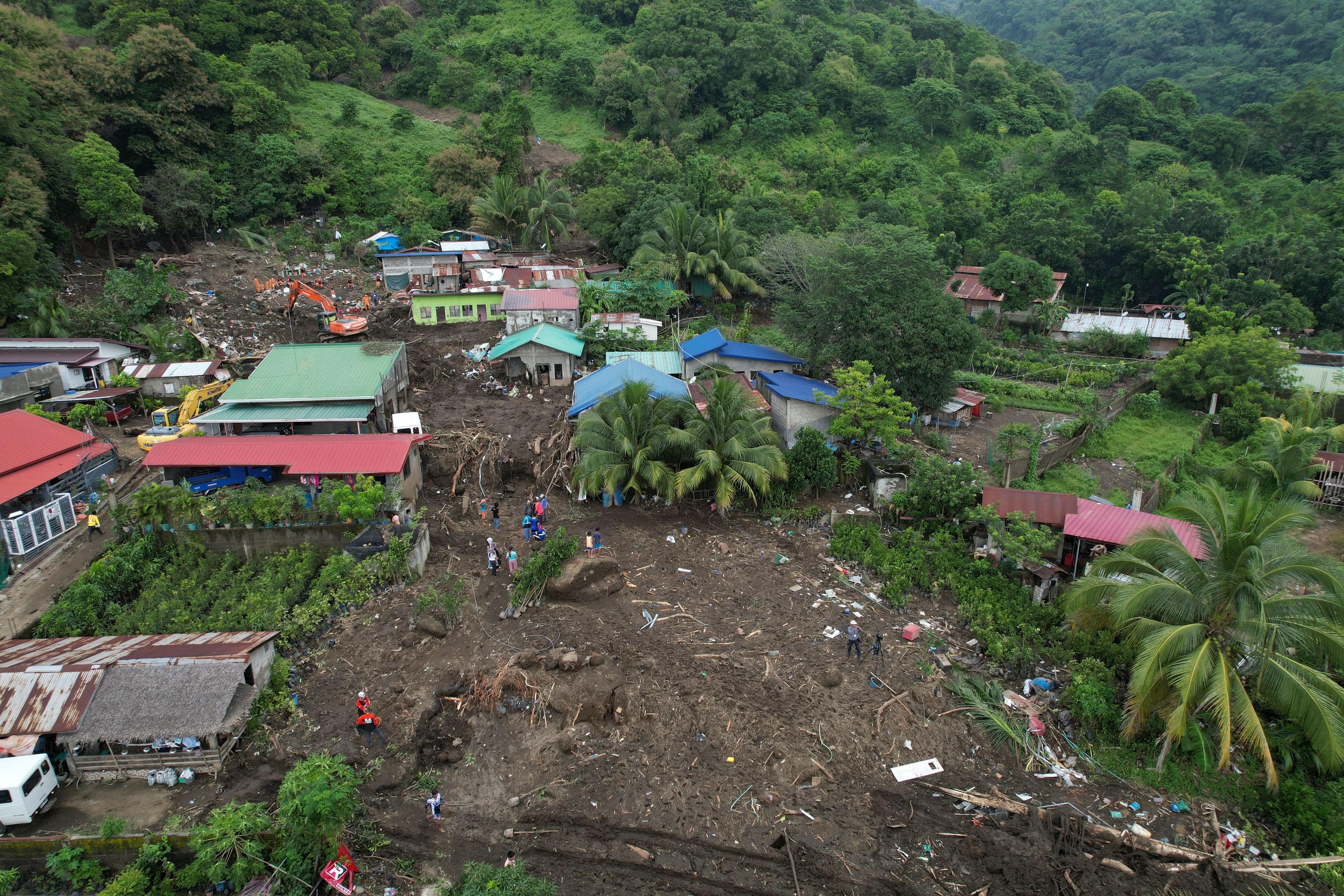 Rescuers work at the site after a recent landslide triggered by Tropical Storm Trami struck Talisay, Batangas province, Philippines, leaving thousands homeless and several villagers dead on Saturday, Oct. 26, 2024. (AP Photo/Aaron Favila)