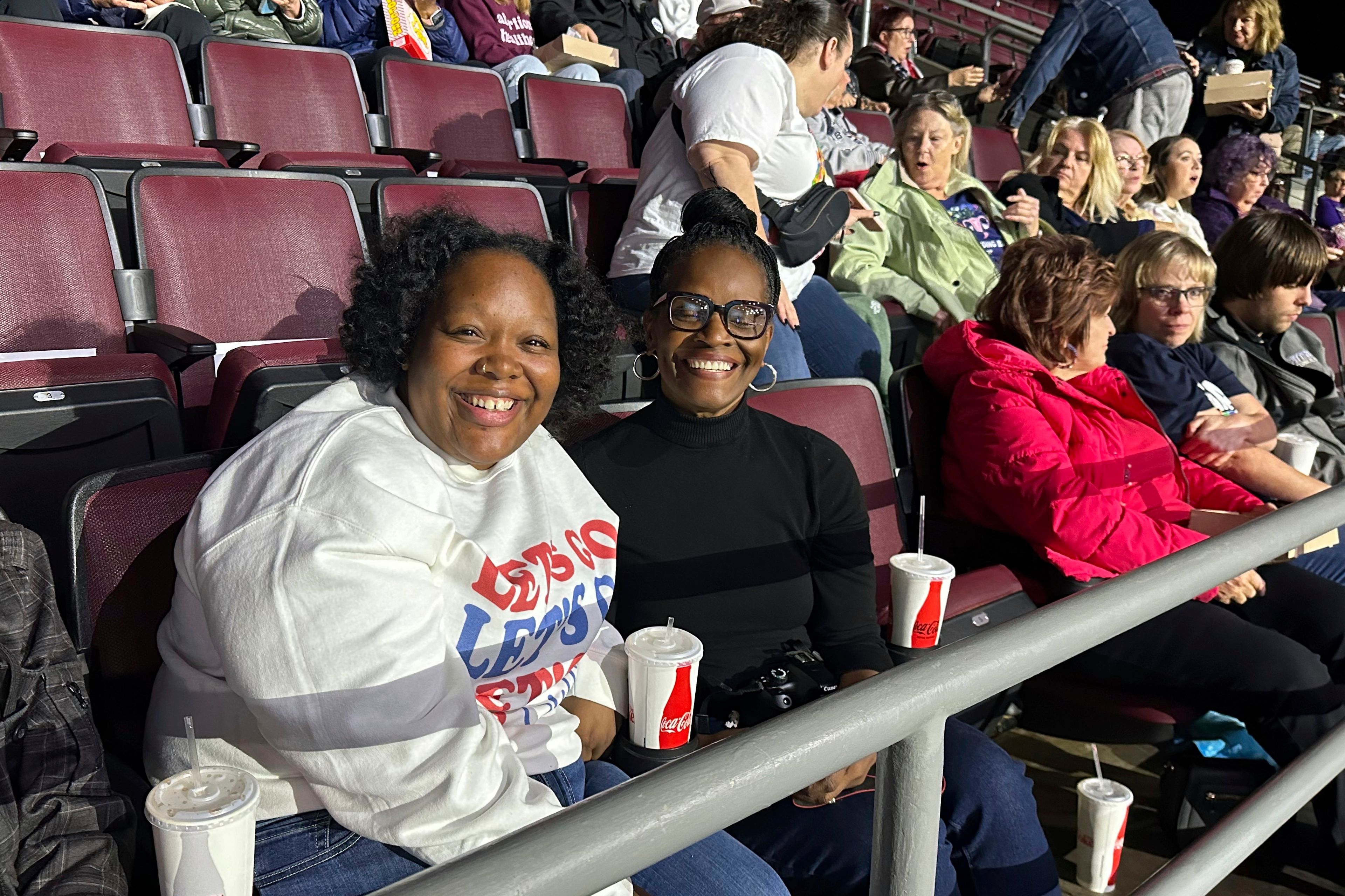 Angela Cox, center, and her adult daughter, Taylor Norton, left, await the start of a Democratic presidential candidate Vice President Kamala Harris rally at the Erie Insurance Arena in Erie, Pa., Monday, Oct. 14, 2024. (AP Photo/Carolyn Thompson)