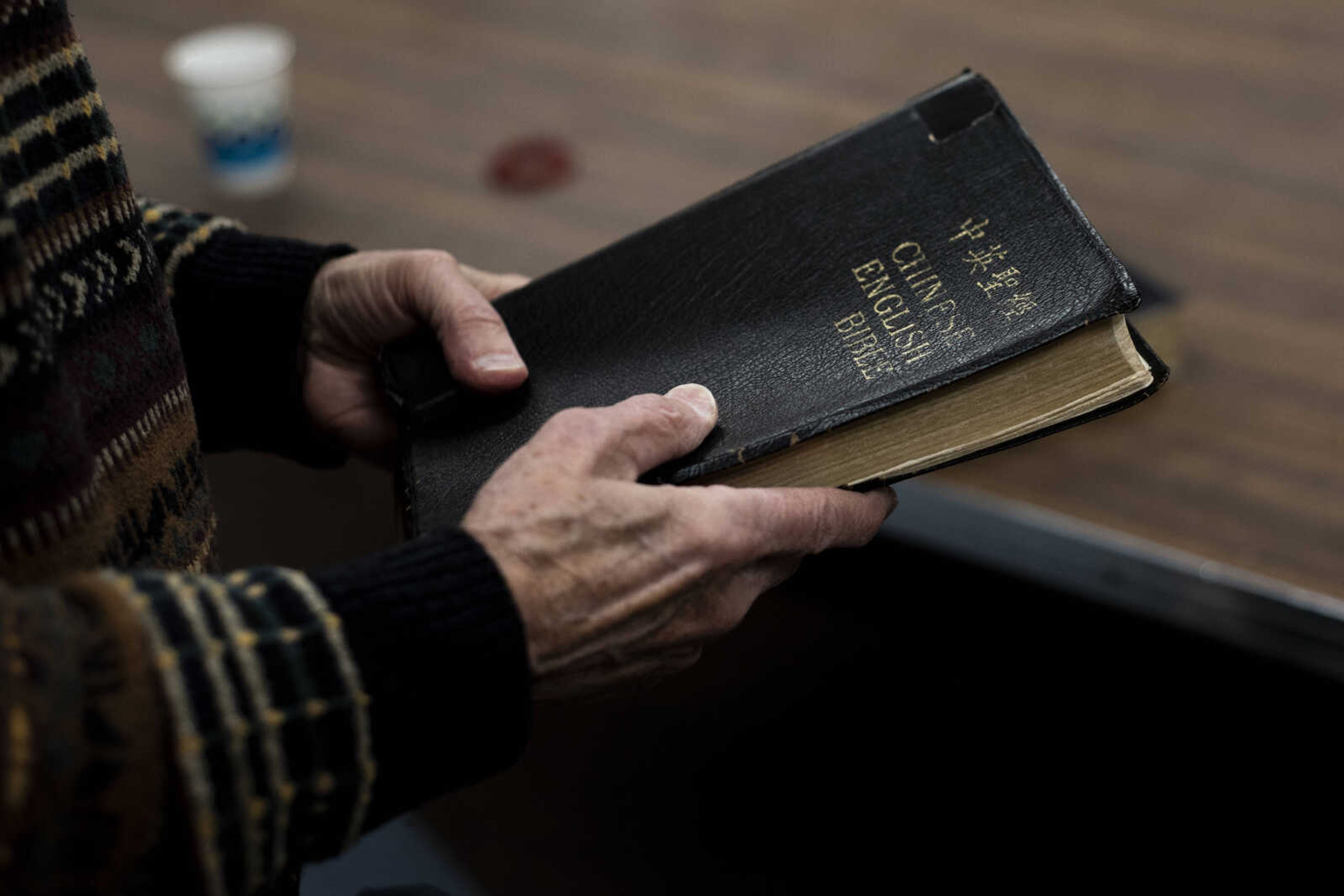 Dr. Ron Winstead holds his Chinese English Bible Friday, March 8, 2019, at the Southeast Missouri State University Baptist Student Center in Cape Girardeau. Winstead's Bible has traveled around with him for at least 40 years, from Taiwan to mainland China. "It's been around the world," Winstead said.